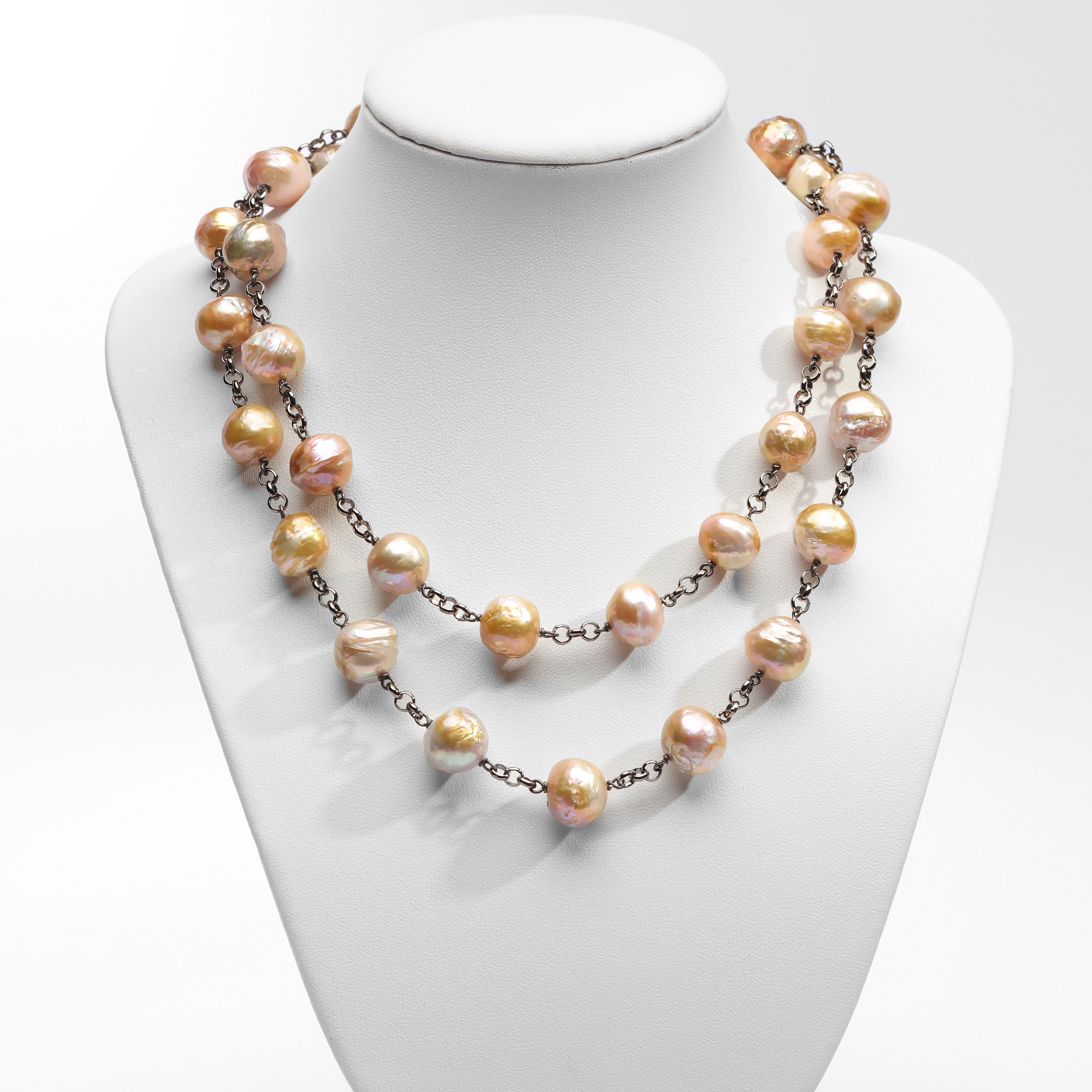 This striking, unique necklace is composed of 35 cultured Chinese freshwater pearls. These undyed, naturally-colored pearls gleam with prismatic rainbow colors as light slides over their rippled, dimpled surfaces. They have an amazing metallic