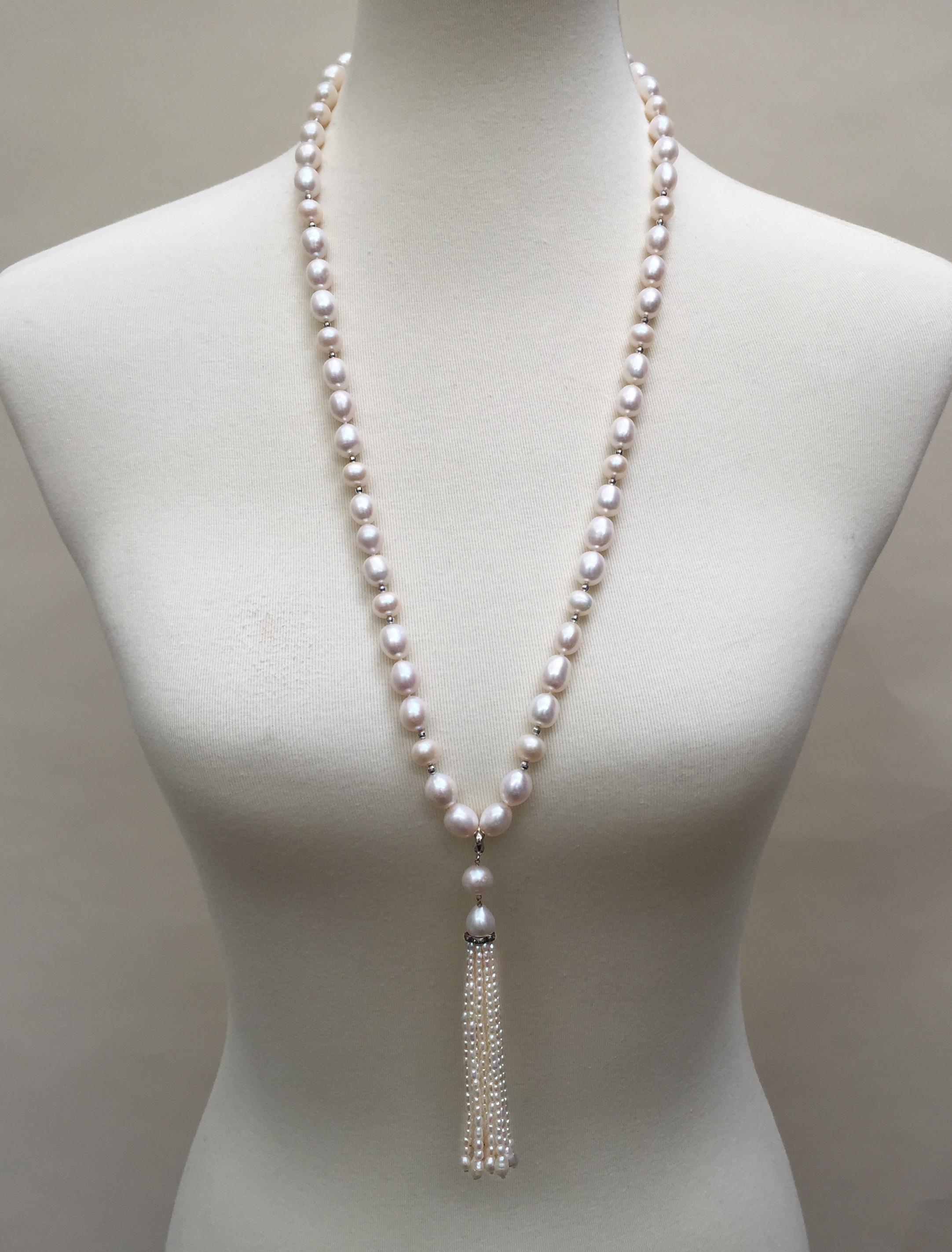This pearl necklace with pearl and diamond tassel and 14k white gold beads and the clasp is an elegant creation by Marina J. Small 14k white gold faceted beads are strung through the necklace adding a modern twist to the classic pearl necklace. The