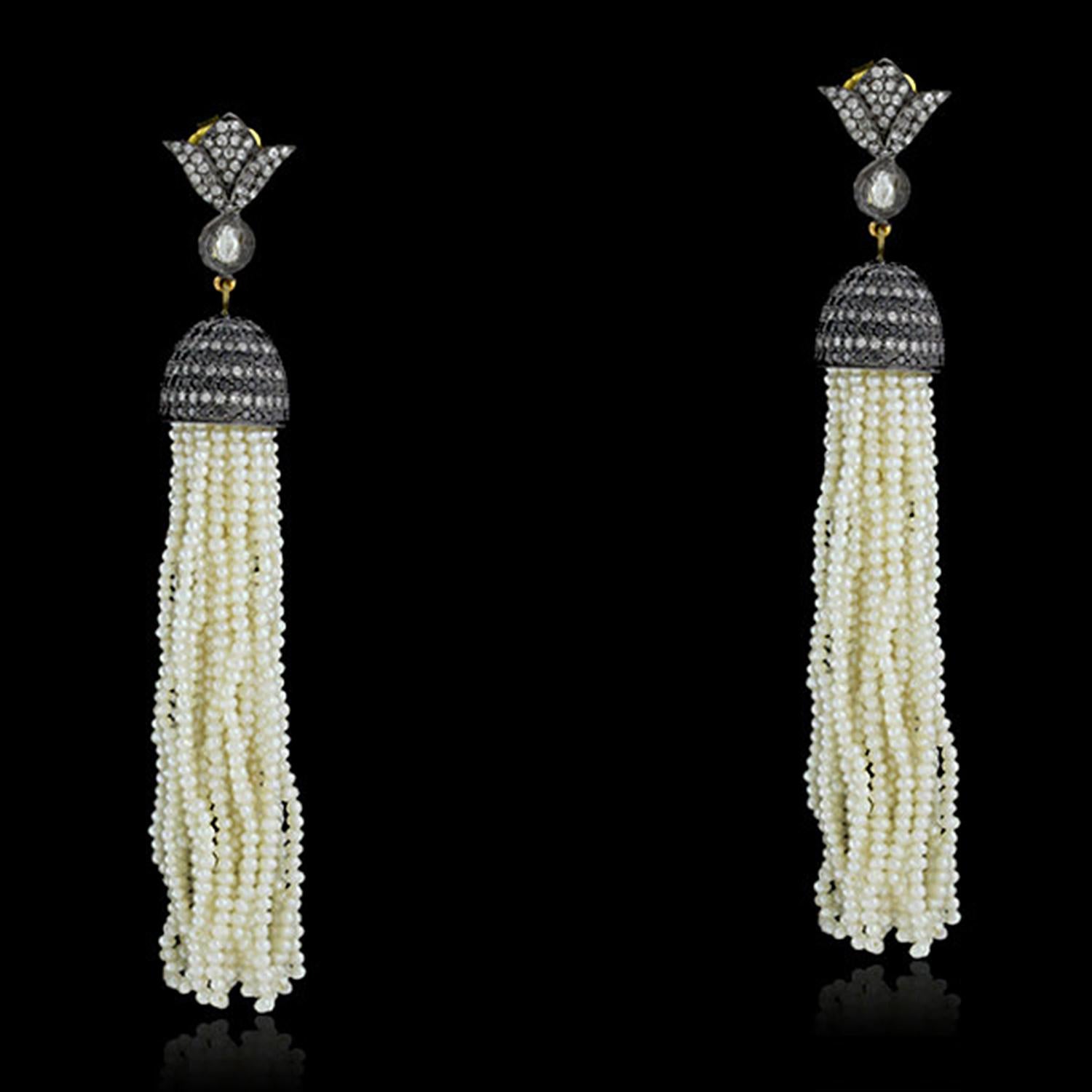 These stunning earrings are handcrafted with the finest materials. The 14k gold and silver setting holds a row of sparkling diamonds, which are encased in a delicate pave setting. The earrings are finished with a pair of lustrous pearls, adding a