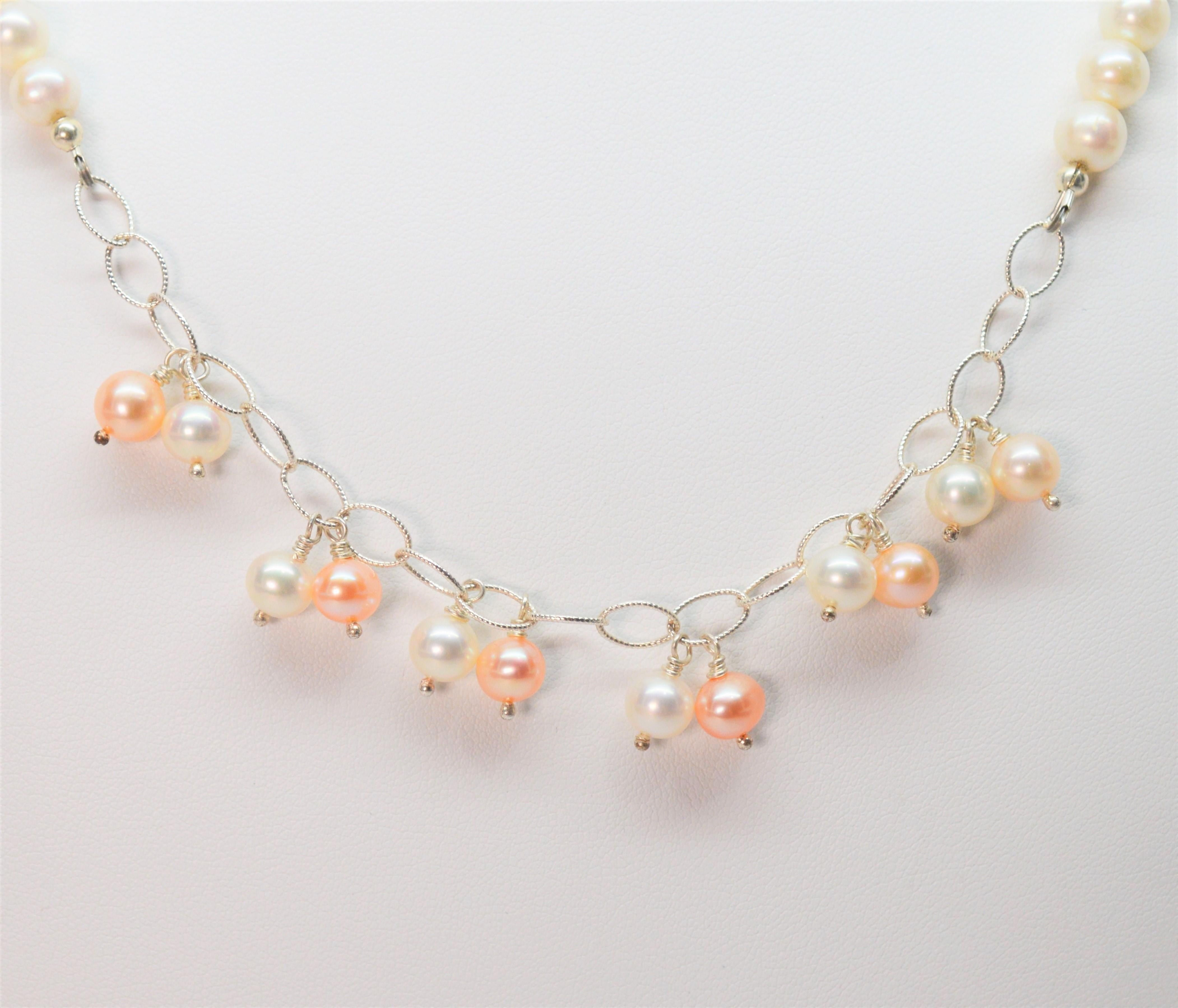 Fresh as a spring rain, this darling artisan made necklace elevates the classic pearl strand with textured oval link silver chain and lustrous droplets of blush and white pearls. Created with 6.5 mm cultured Button Akoya Pearls, the necklace