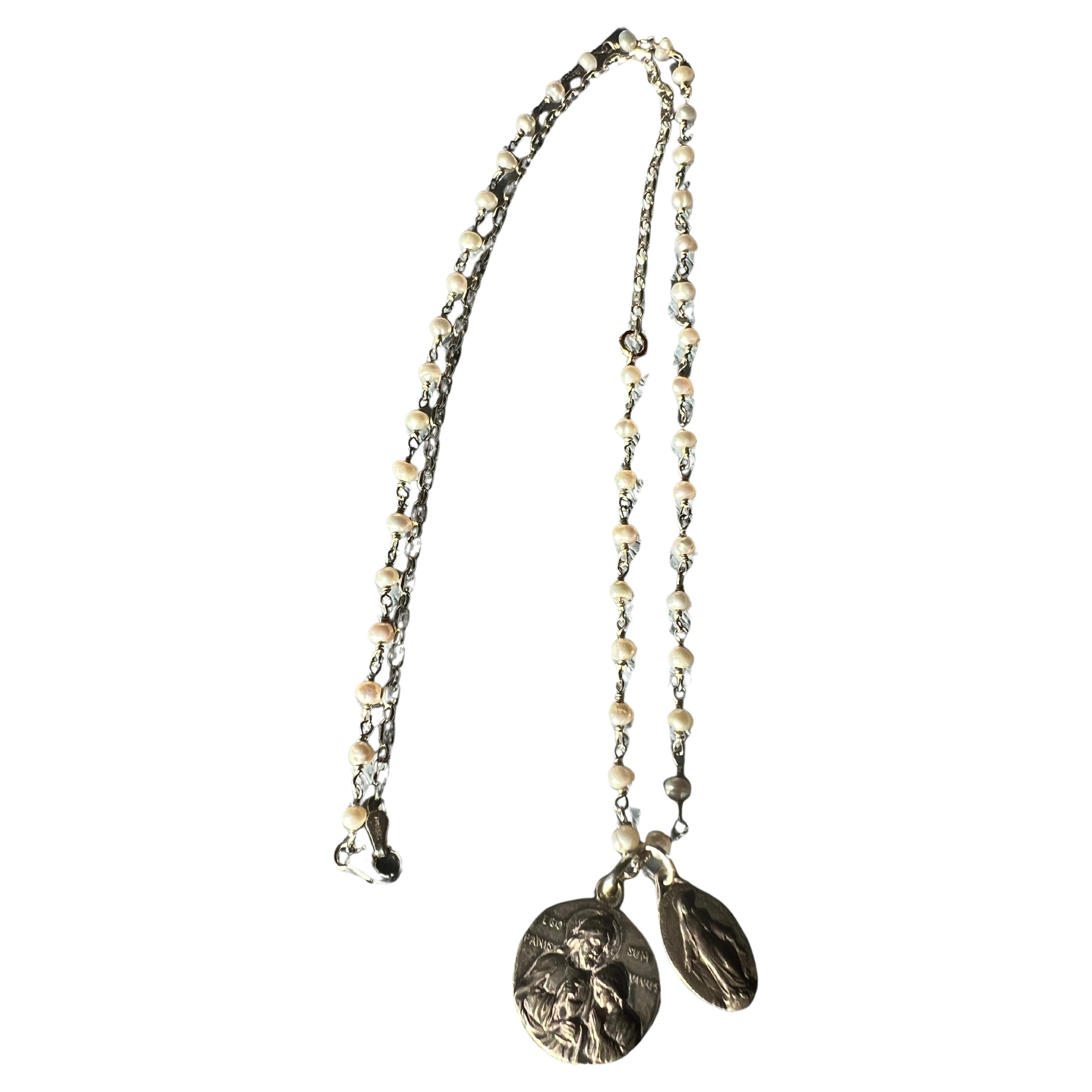 White Pearl Rosario Religious Chain Necklace Double French vintage silver plated medals

Length: 24 inches

In the broader context of Catholic iconography, the medals encourage a personal and protective connection to the divine, reflecting a