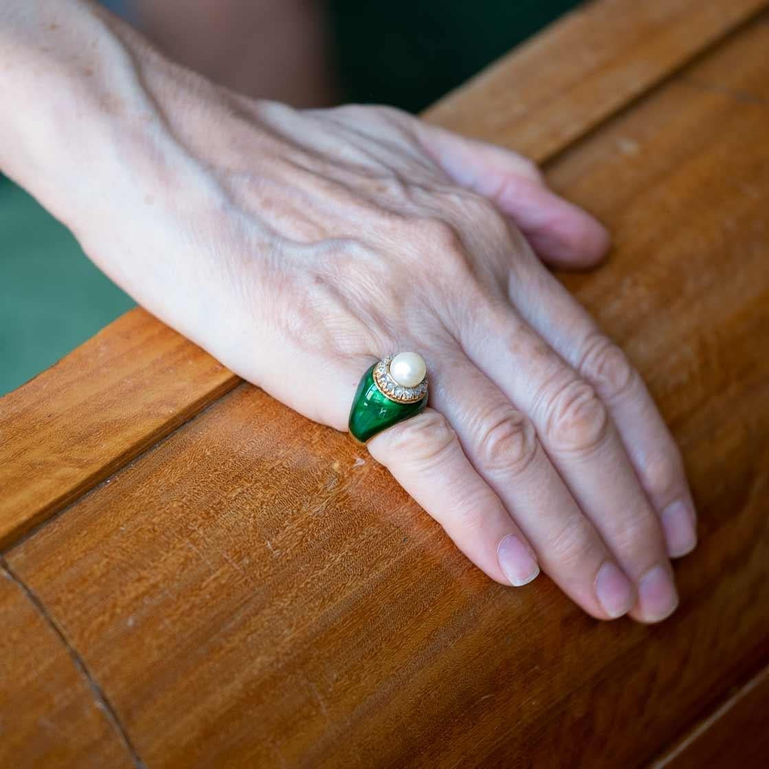 Unusual ring from the 1960s with green enamel typical of the period set in 18ct gold, featuring a Japanese cultured pearl surrounded by rose cut diamonds.

Highlights
- 1960s period with green enamel
- Rose cut diamonds
- Cultured Japanese pearl