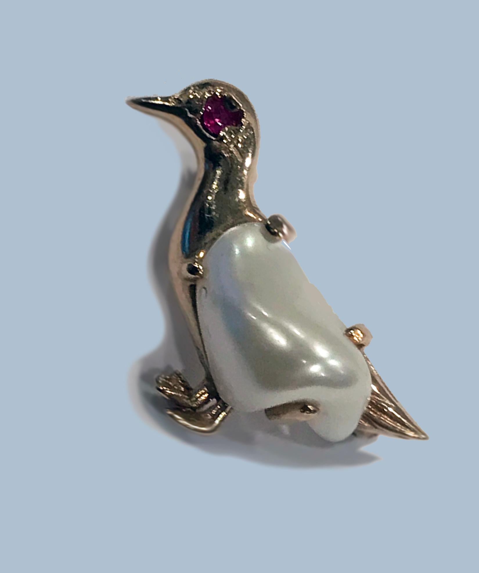 Vintage Pearl and Ruby Brooch in the form of a standing Duck. The body of duck gold bezel set with a baroque pearl conforming in shape to body of duck, the eye inset with small ruby; gold realistically textured feet. Measures: Approximately 23.00 x