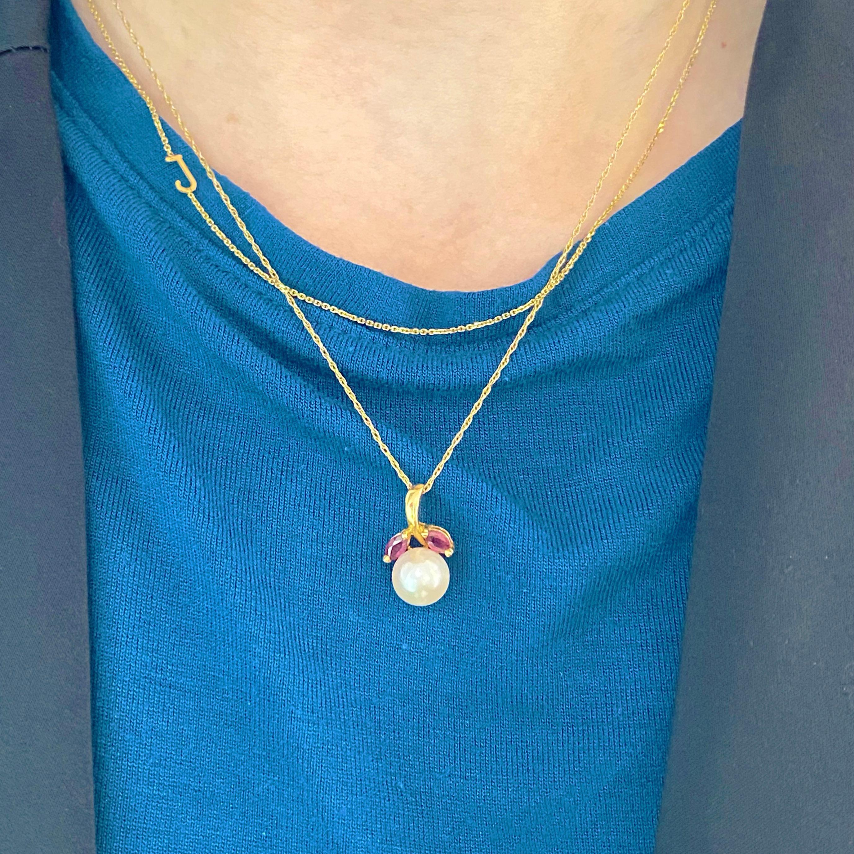 Pearls and rubies are a beautiful combination and this pendant has this very design!  The genuine cultured salt water, Japanese pearl has a gorgeous luster, orient, and a beautiful white color.  There are two gorgeous marquise red rubies accenting