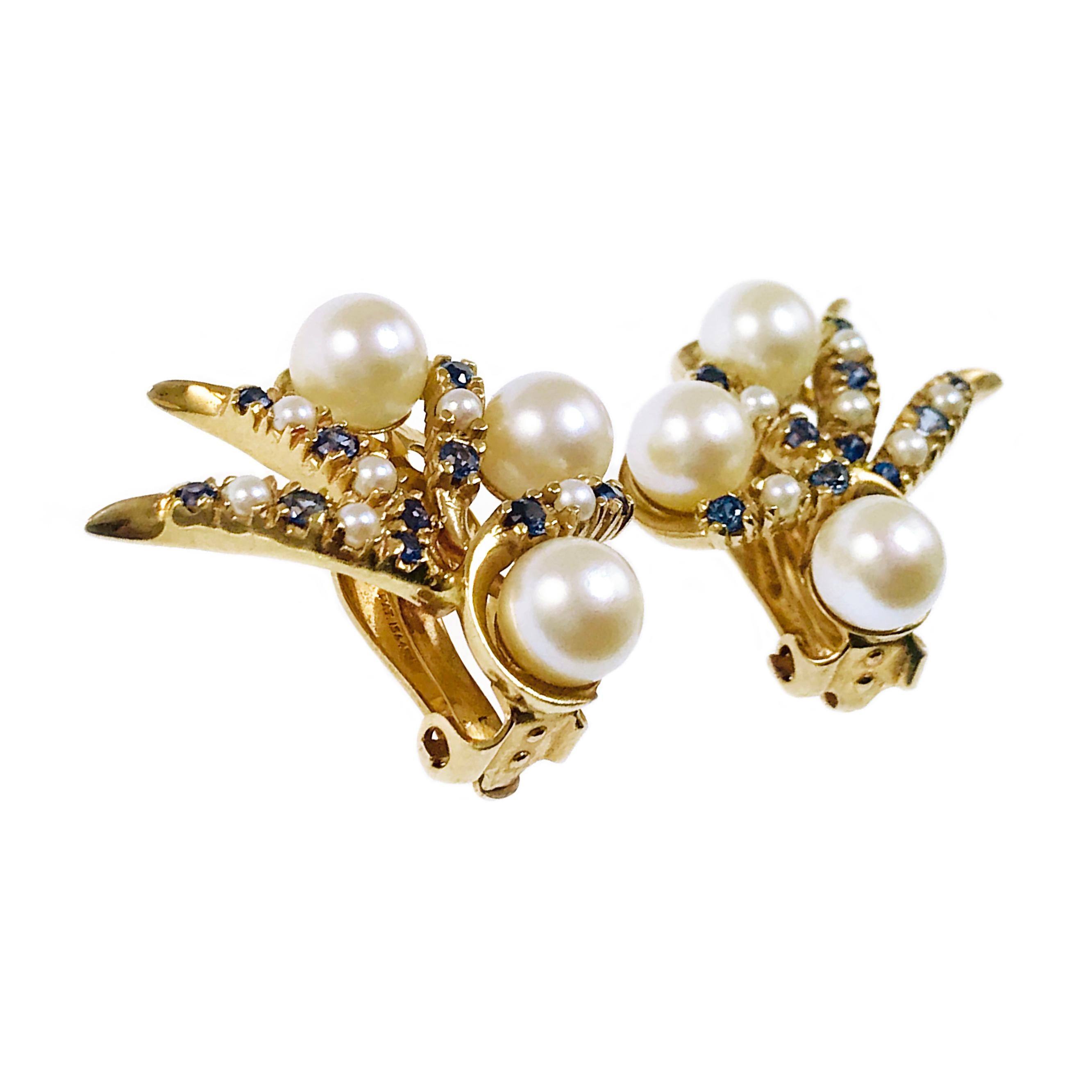 Pearl Sapphire Clip-On Earrings. Three large pearls 6.5mm adorn each earring, six smaller pearls and ten blue sapphires are bead-set in swirls of yellow gold. The 2mm round sapphires have an approximate weight of 0.04ctw, sapphires are approximately