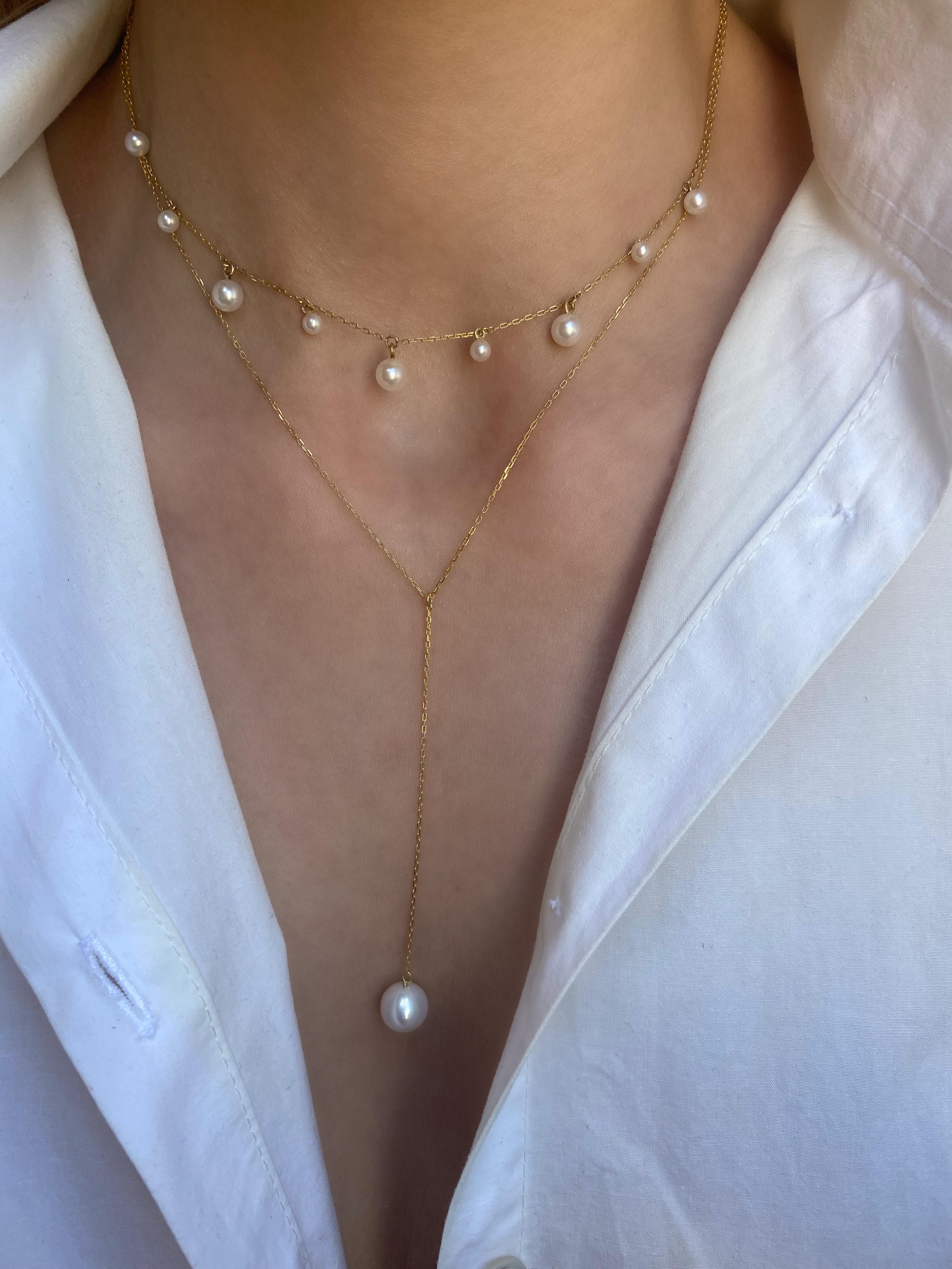 An array of dangling mini pearls hanging from a delicate chain fitted closely around the neck. A modern choker necklace that adds a touch of playfulness to any look.
18 Karat Yellow Gold
Freshwater pearls, 3mm – 5mm
Choker length is 32cm/12.59in