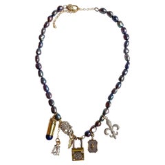 Pearl, skull and golden lock multi charm necklace