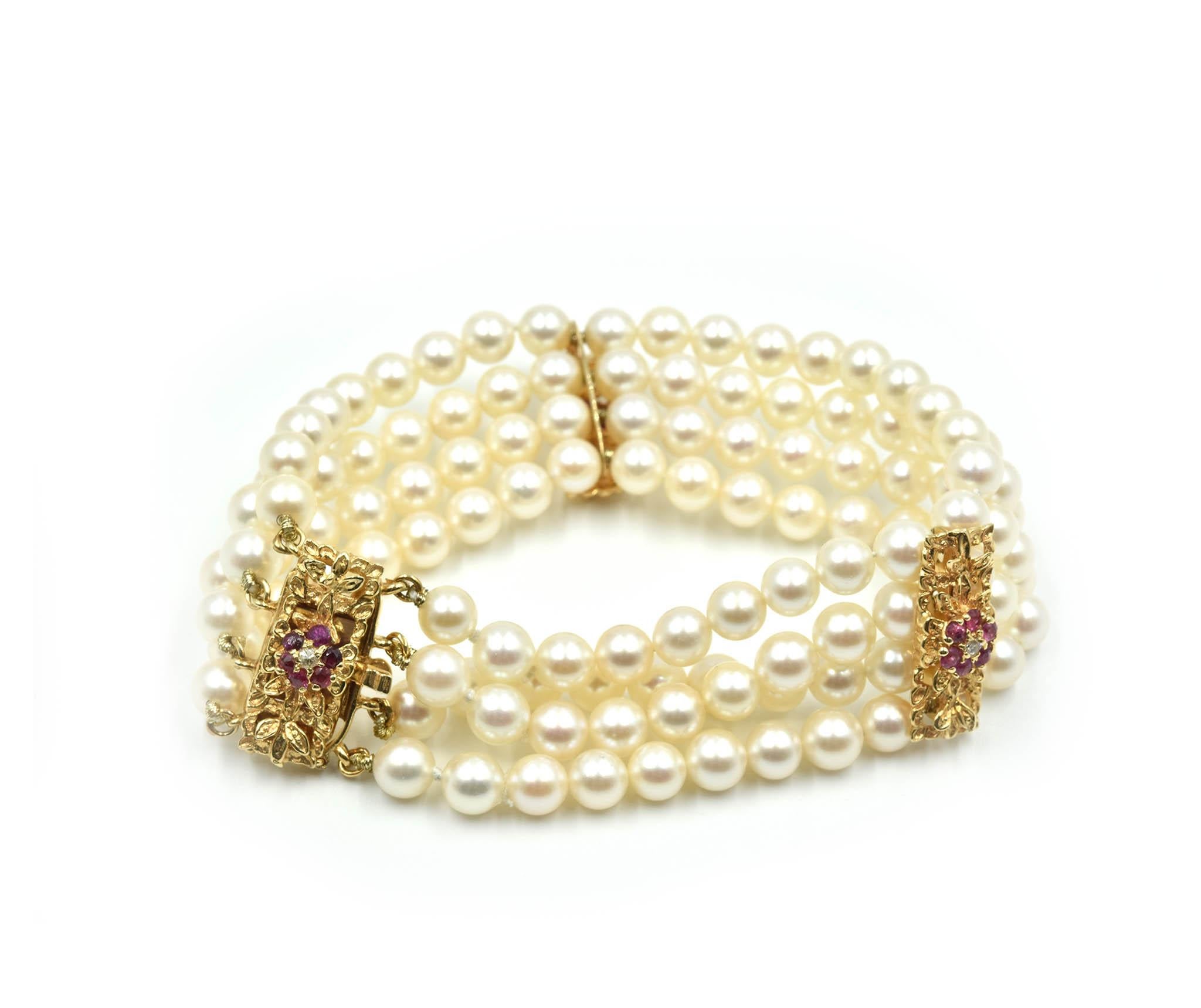 Designer: custom design
Material: 14k yellow gold
Pearls: cultured pearls 5.65mm in diameter
Rubies: 18 round cut rubies = 1.26 carat total weight
Dimensions: bracelet will fit up to a 6 ½ inch wrist, bracelet is 1 inches wide
Weight: 38.29 grams
