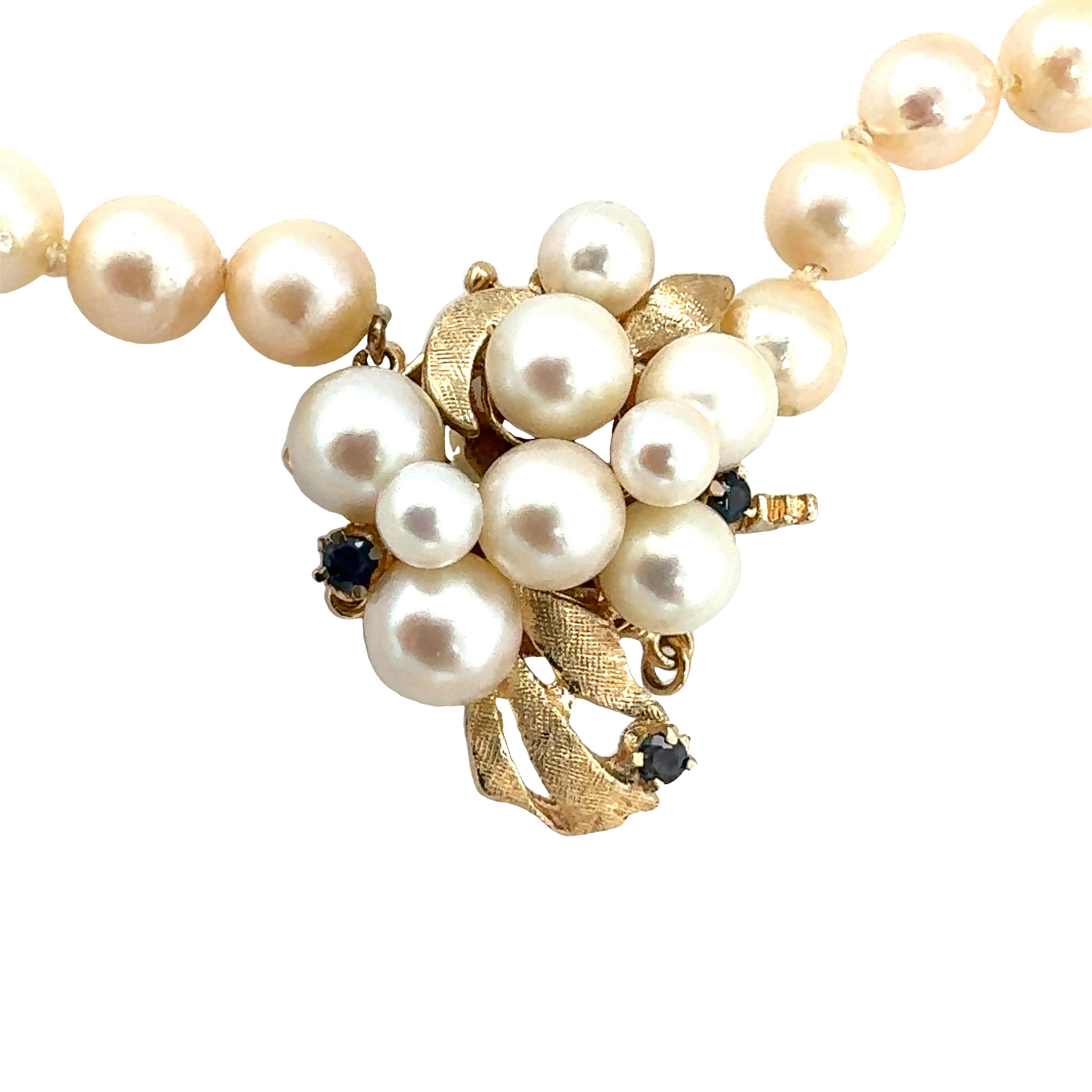 One pearl strand necklace with 48 cream color, round cultured pearls measuring 7 millimeters in diameter. With pearl and sapphire clasp with pearls measuring 4.50-6.50 millimeters in diameter and 0.12 ct. in total sapphire weight.

Gemstone:
