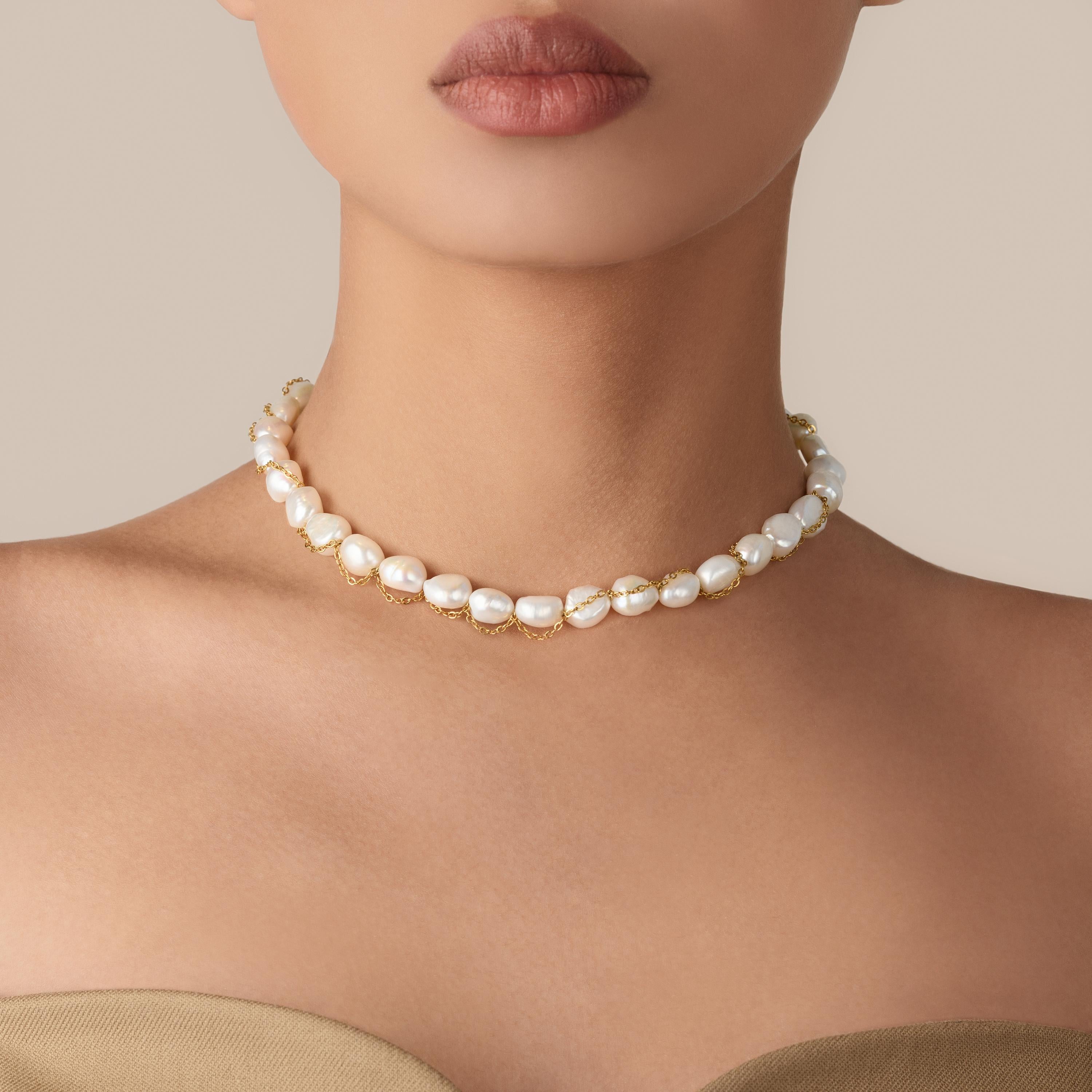Indulge in the lavishness of our meticulously crafted Baroque Pearl Necklace, a true embodiment of refined sophistication. This exquisite piece combines the allure of 10-11 mm baroque pearls with the opulence of an 18K gold plated stainless steel