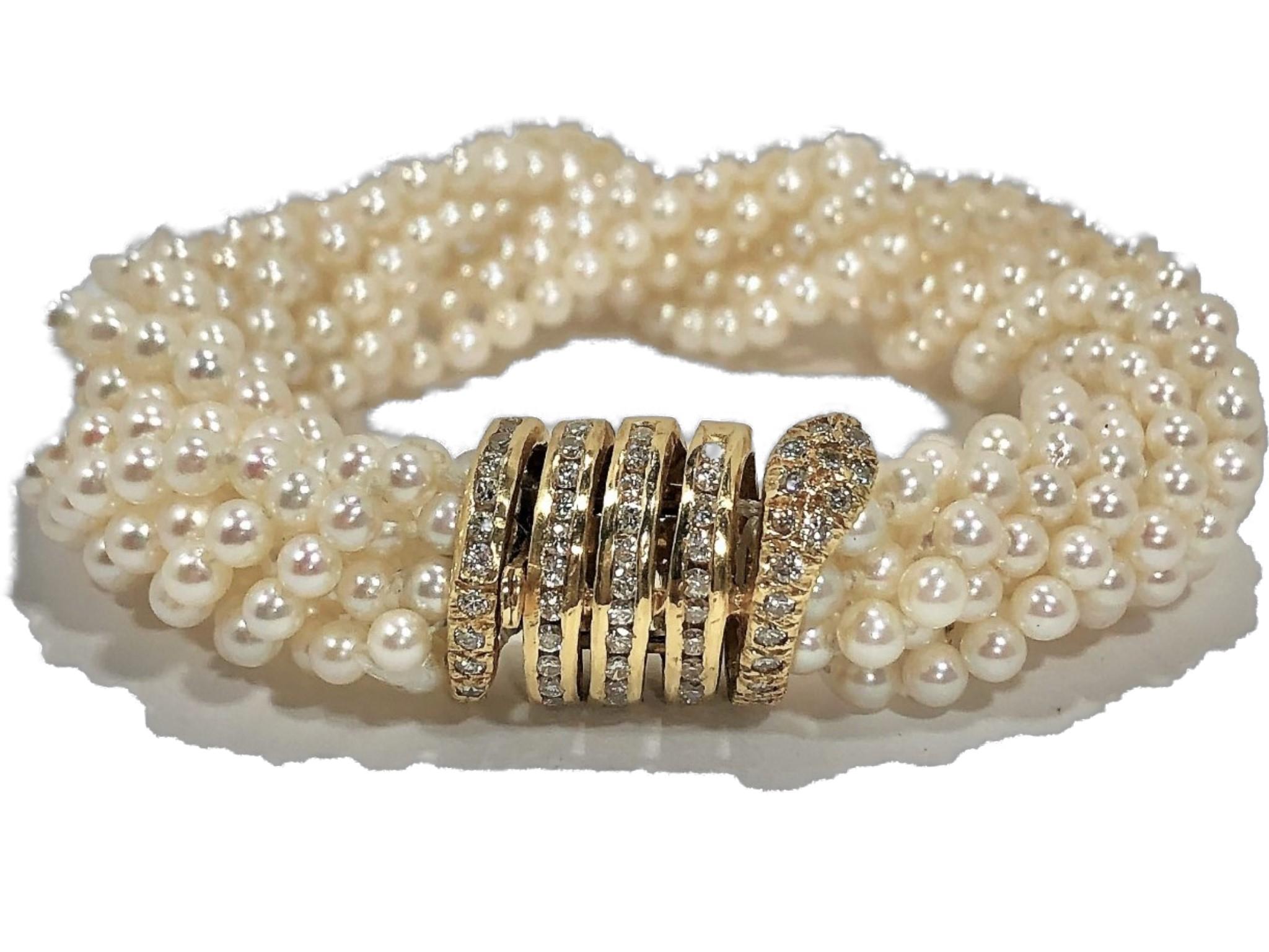 Fashioned in Italy, this 10 strand cultured pearl bracelet comes
with a delicate, beautifully crafted 18K Yellow Gold coiled snake 
clasp, set with 61 round brilliant cut diamonds weighing an
approximate total of 1.0CT of overall F/G Color and VS1