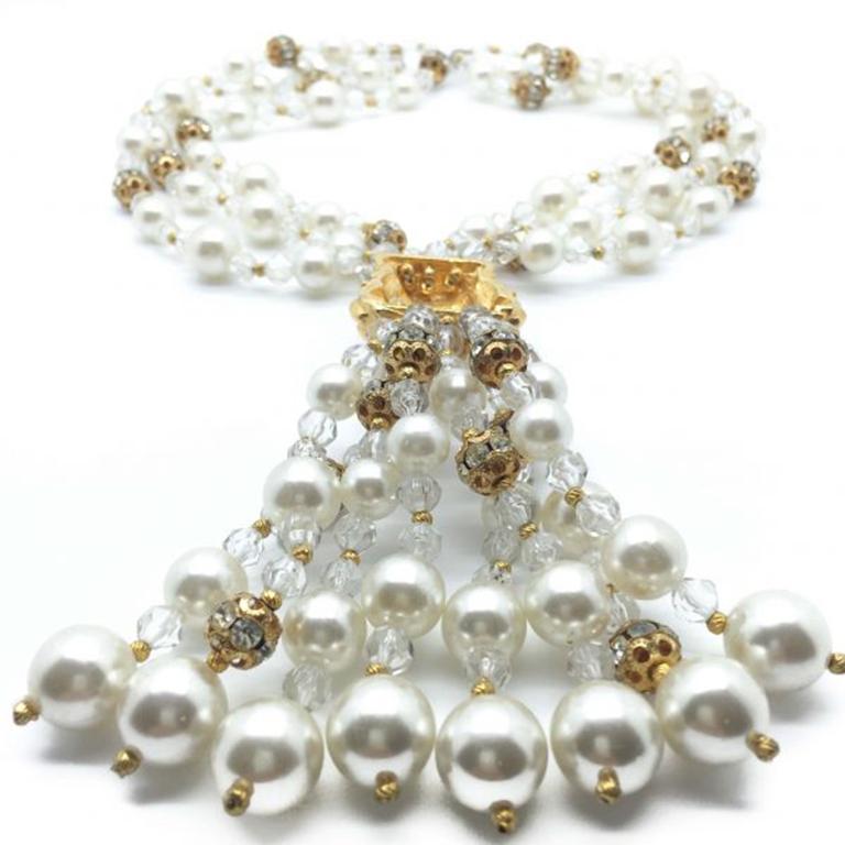 A striking vintage pearl necklace combining the glamour of glass pearls alongside the richness of the gilt and sparkle of crystals. The design of this piece is magical and laden with jewels and this vintage pearl necklace is certainly a one of a
