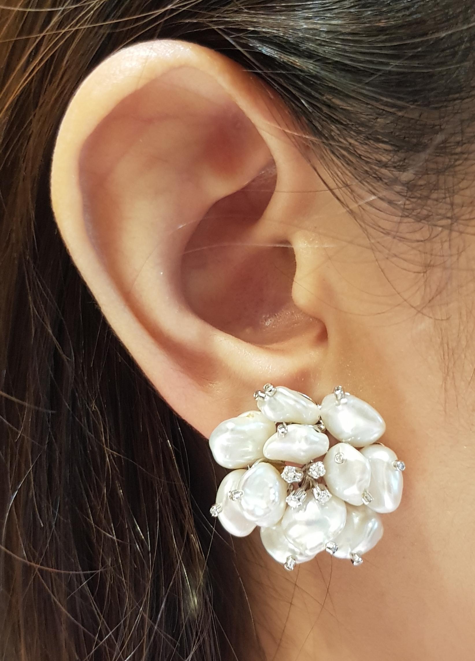 Pearl with Diamond 0.29 carat Earrings set in 18 Karat White Gold Settings

Width:  2.6 cm 
Length:  2.6 cm
Total Weight: 18.69 grams

