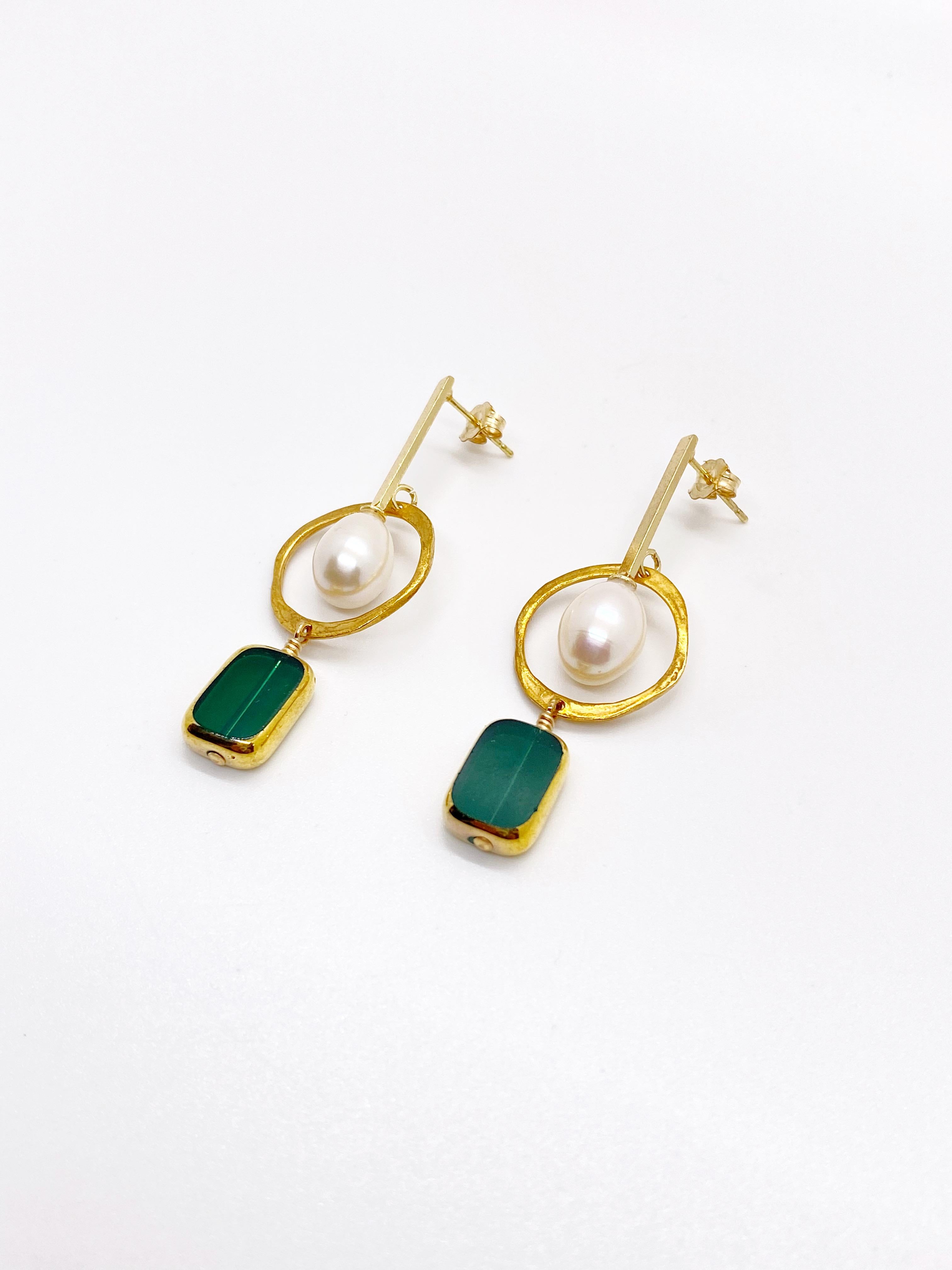 This is for a pair of earrings. These earrings consist of transparent emerald green vintage German glass beads that are edged with 24K gold and a freshwater pearl as the focal point. All metals are 24K gold plated.

The vintage German glass beads