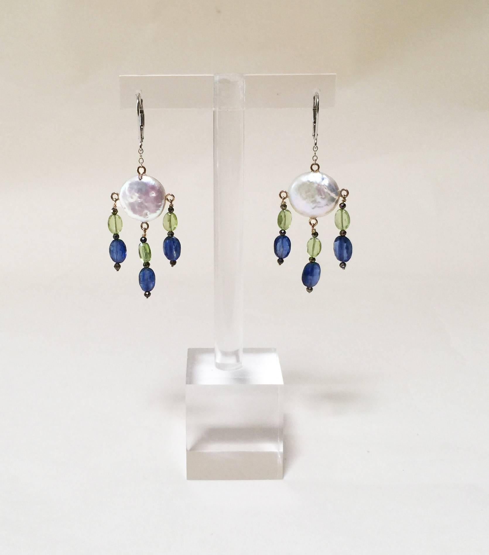 Gorgeous pair of Chandelier Earrings by Marina J. This elegant pair features a faceted Peridot, Kyanite and Black Spinel adorning a Baroque White Coin Pearl. The Pearl displays a stunning iridescent luster which perfectly compliments the multi