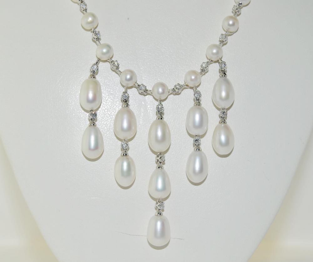 Ladies necklace featuring white round and drop cultured pearls and 0.42 carats brilliant round diamonds.  This necklace is made of 14 Karat White Gold, chain length 18 inches.