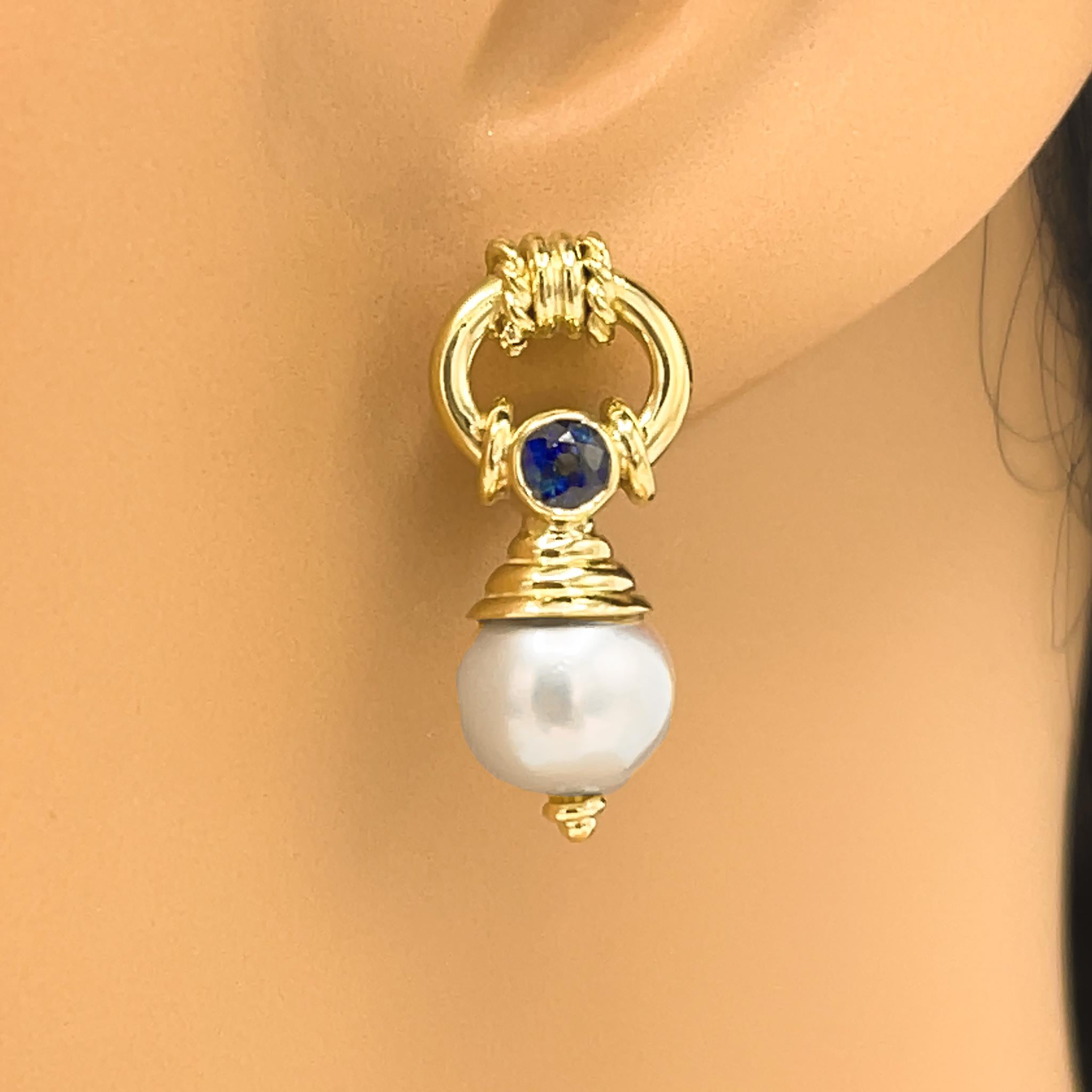 If you're looking to add a jewelry classic to your collection, this luxurious pair of earrings is a choice you cannot go wrong with.  They're designed for lasting wear, and beauty.

18 kt Yellow Gold
Pearl: 8.5 mm
Sapphire: 0.40 ct twd