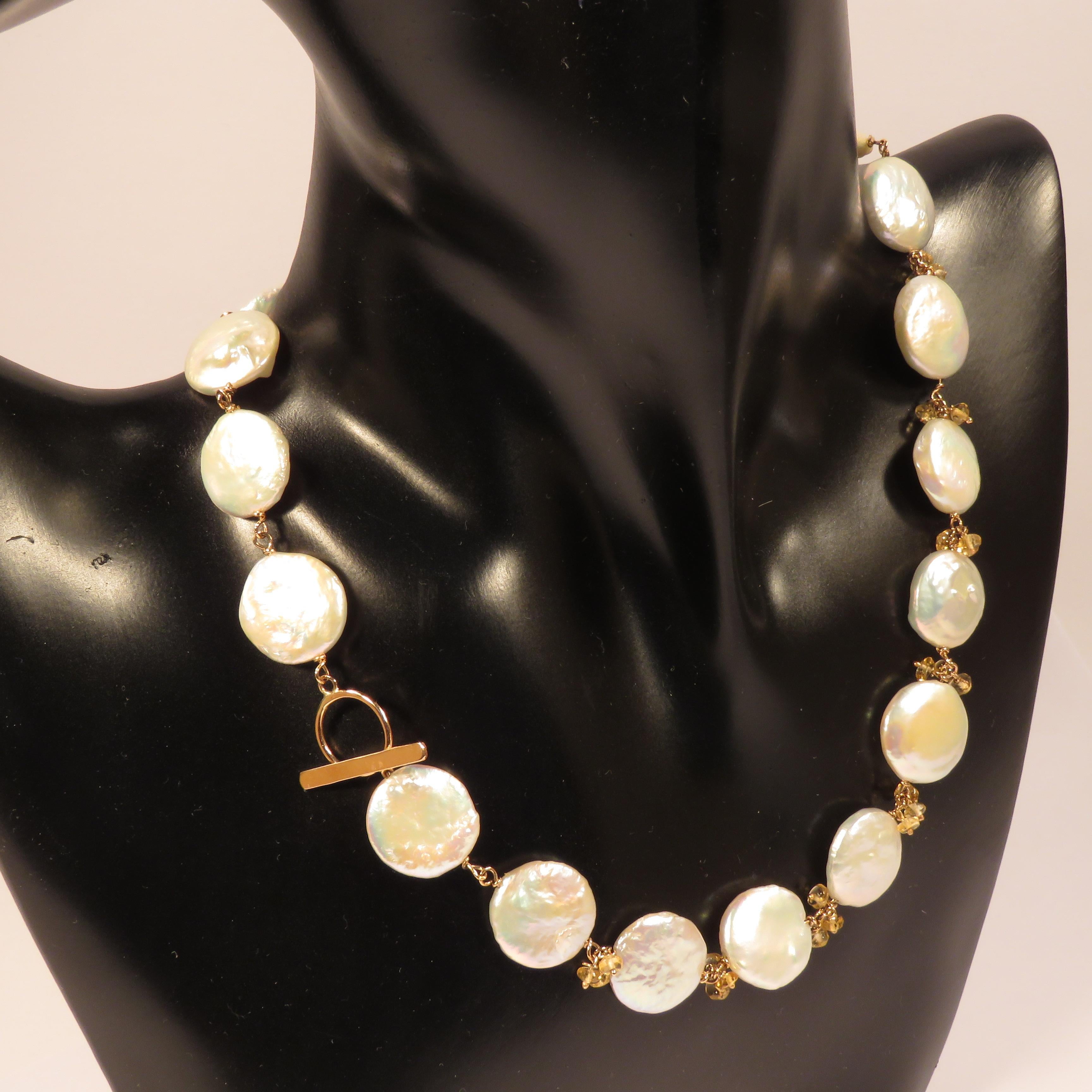 This freshwater white pearls necklace is chained in 9 karat rose gold with yellow citrines. The necklace lenght is 400 millimeters / 15.748 inches, the circumference of each pearl is 15 millimeters / 0.590 inches. This item is marked with the