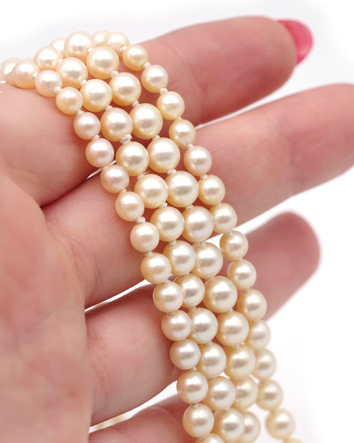 Pearls double strand necklace with 18 karat white gold clasp. This necklace features two strands of falling cultured pearls, with the first strand consisting of 91 pearls and the second strand consisting of 85 pearls. The pearls range in diameter