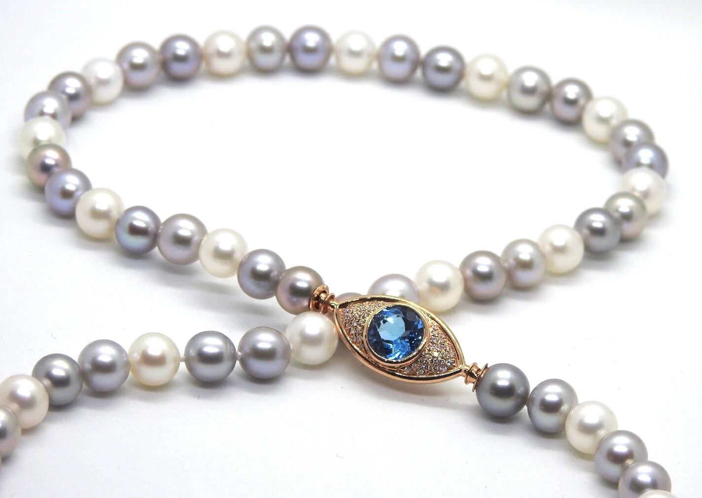 ARGOS necklace is a strand of  8mm cultured pearls, with 18K rose gold 