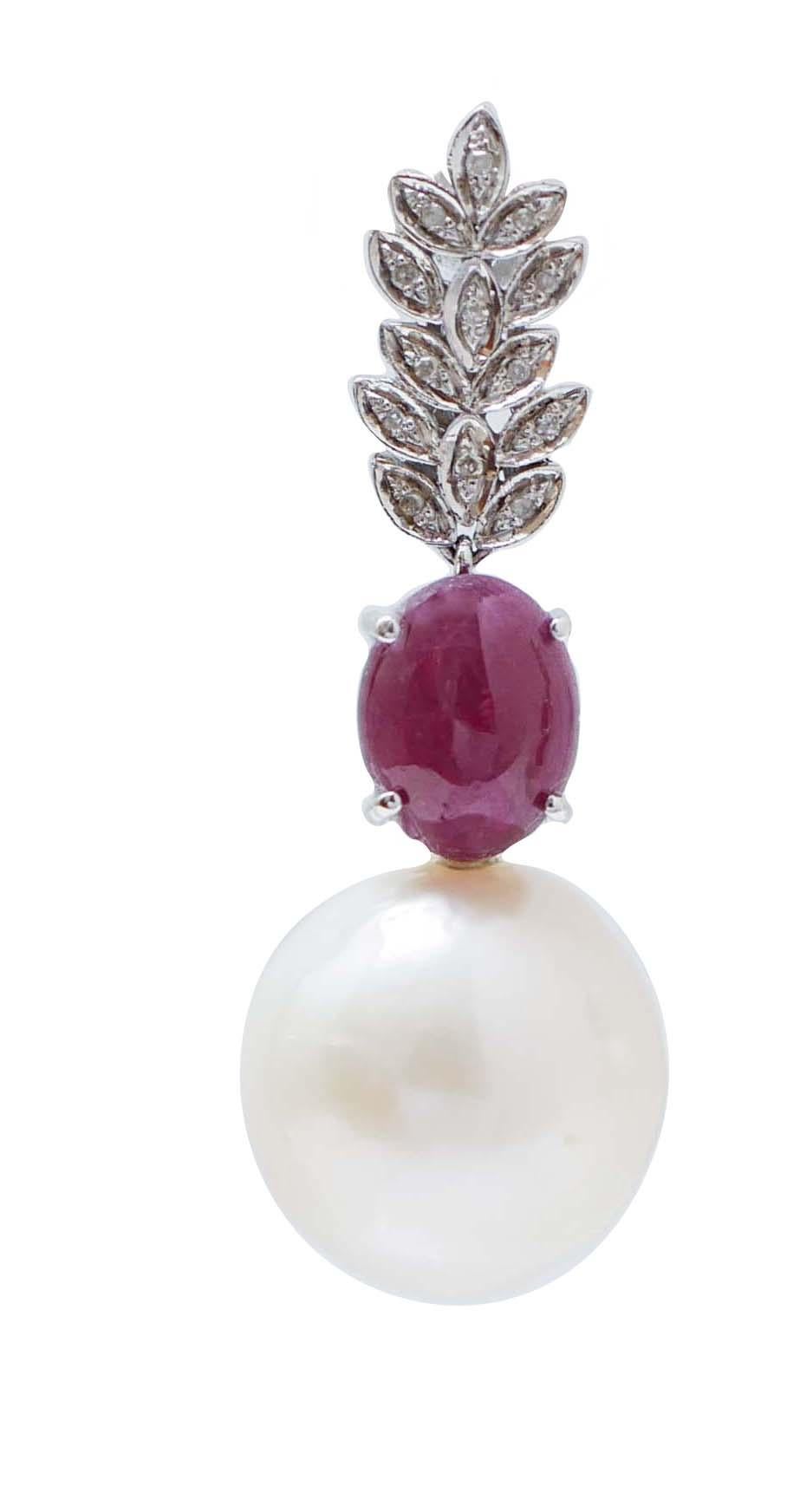 Gorgeous dangle earrings in 14 kt white gold structure mounted with gold leaves studded with diamonds; in the middle, an oval ruby ad,as pendant, a pearl.
These earrings were totally handmade by Italian master goldsmiths and they are in perfect