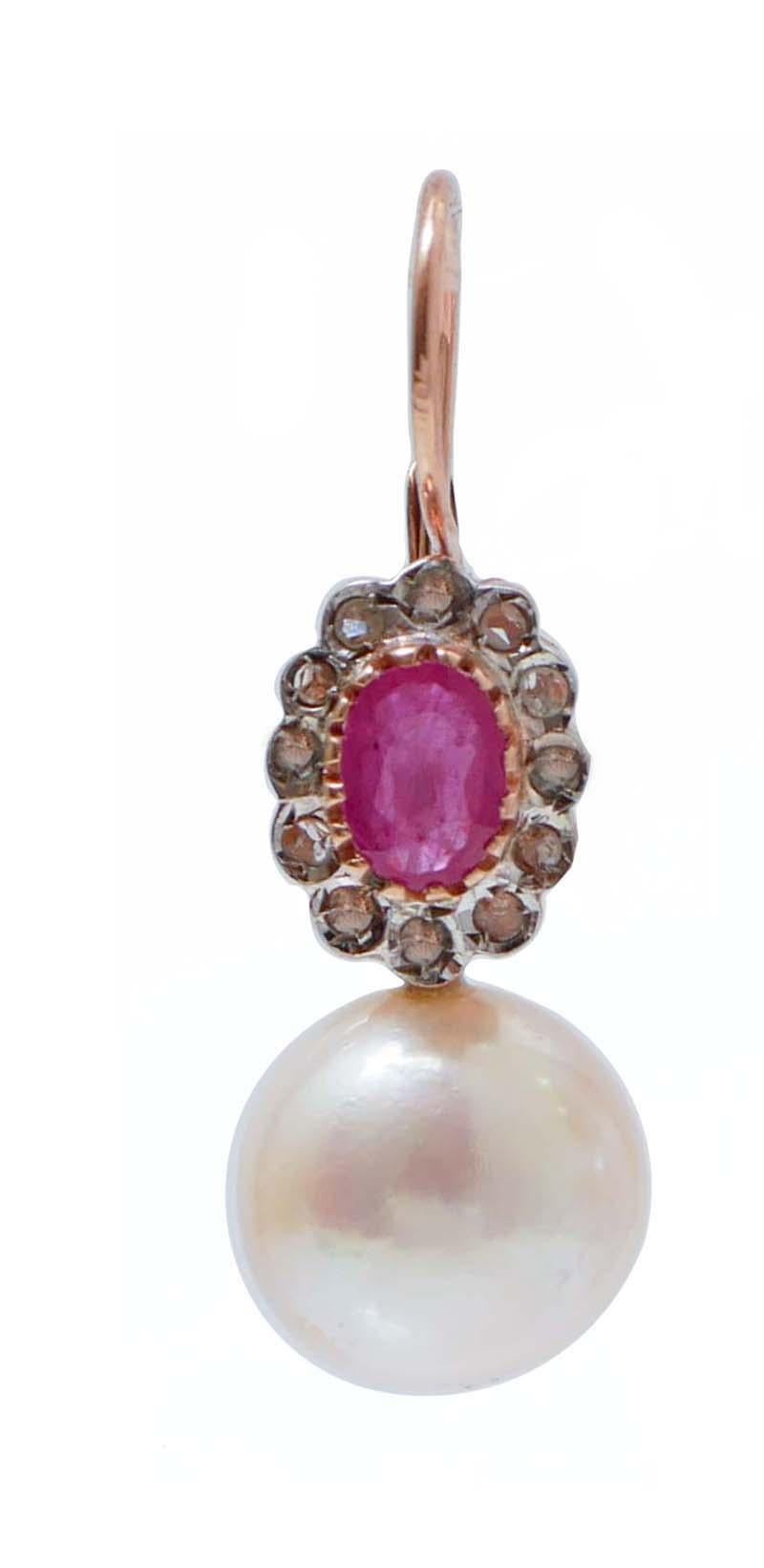 Beautiful earrings in 9 kt rose gold and silver structure mounted  with a ruby surrounded by a frame of diamonds and, below, a pearl.
These earrings were totally handmade by Italian master goldsmiths and they are in perfect conditions.
Diamonds 0.19
