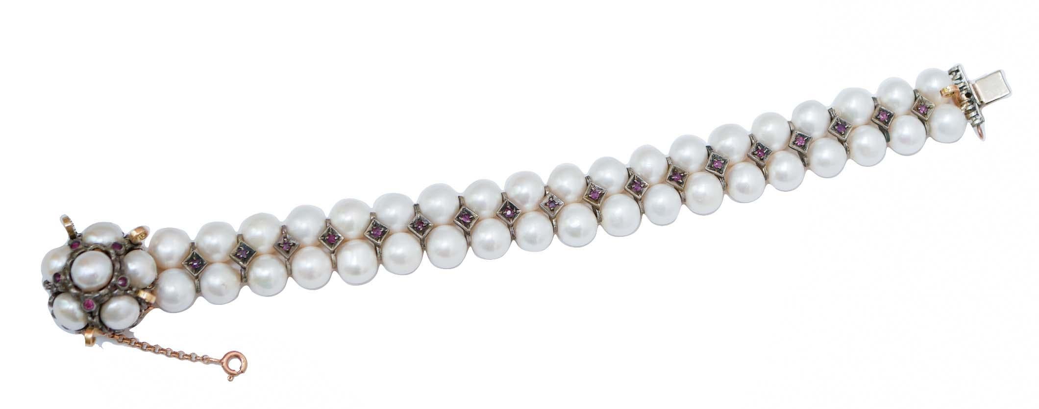 Retrò bracelet in 9 kt rose gold and silver structure mounted with a clasp in rose gold and silver studded with pearls and rubies. All the length of the bracelet is mounted with two strands of pearls alternated with silver structures mounted with a