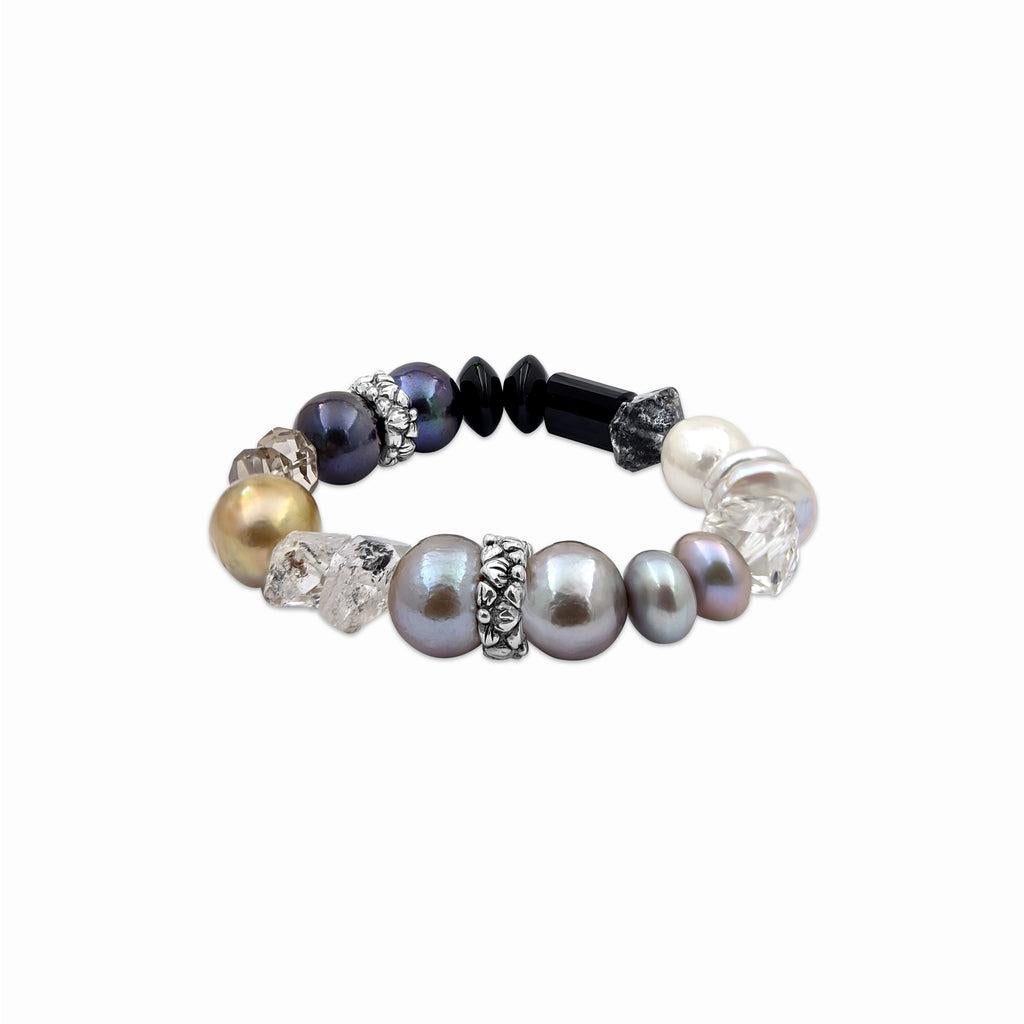 Indulge in the luxurious allure of pearls, black agate, Herkimer diamond, rock crystal, and smoky quartz with this exquisite Stretch Bracelet crafted in sterling silver by Stephen Dweck. Each element in this stunning piece symbolizes elegance and
