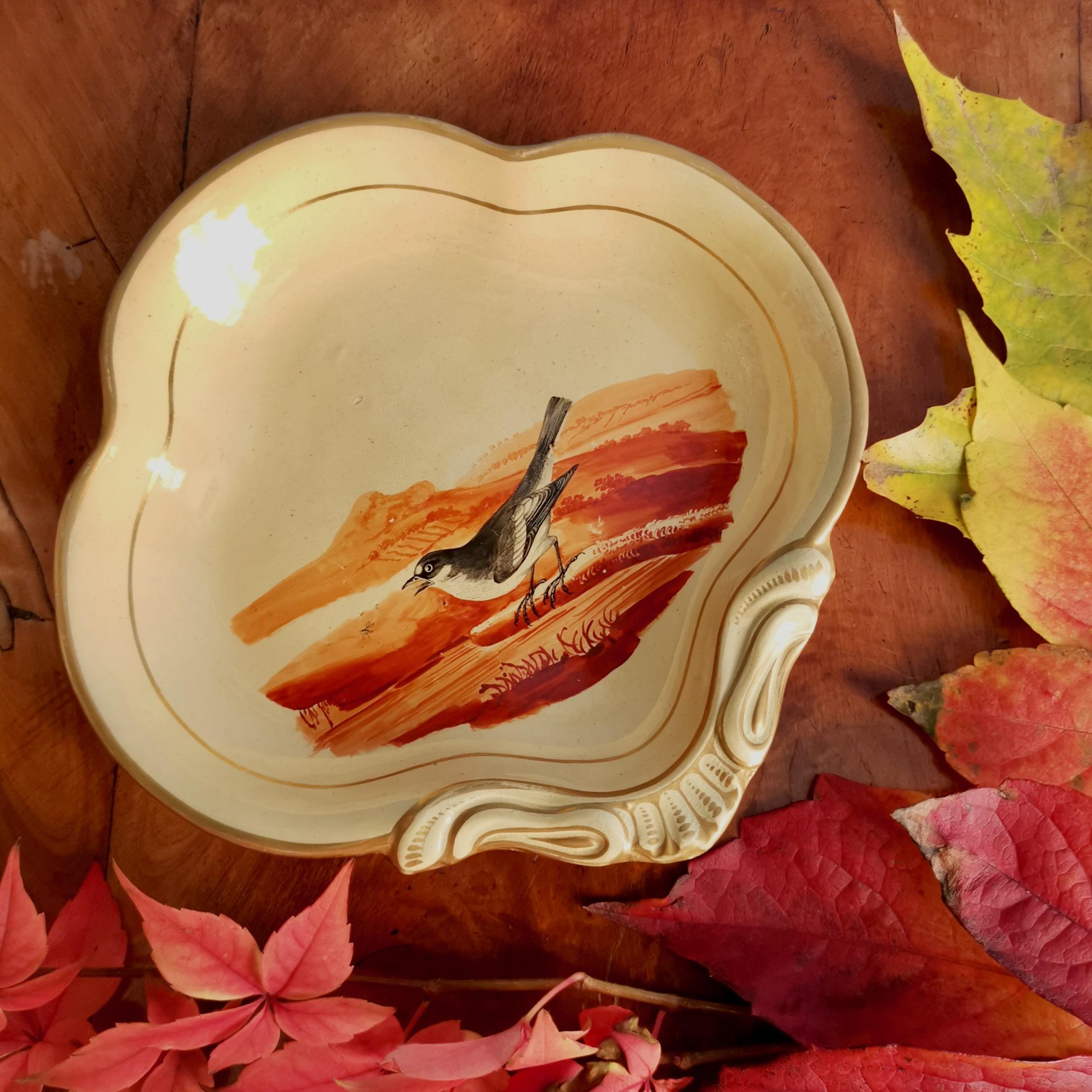 This is a very charming and rare pearlware shell dish made by Wedgwood in circa 1820. The dish has a beautiful beige ground and is painted with a bird in iron red.

Wedgwood is one of the original great potteries of Staffordshire in England. While