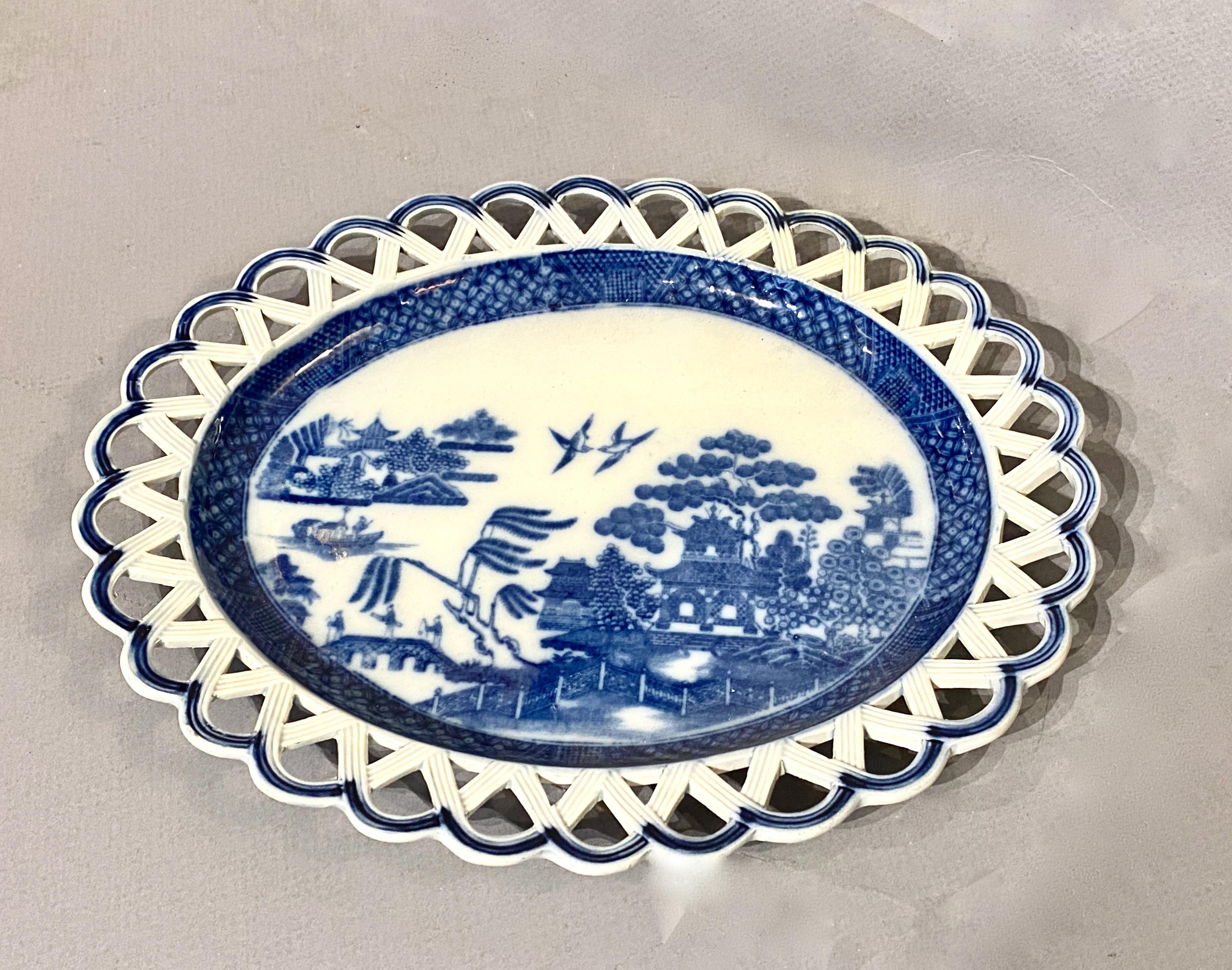 This is a good example of a late 18th c. or early 19th c. small reticulated blue and white Pearlware platter. The platter is in overall very good condition with no faults noted. Pearlware was developed in the late 18th century; once the transfer