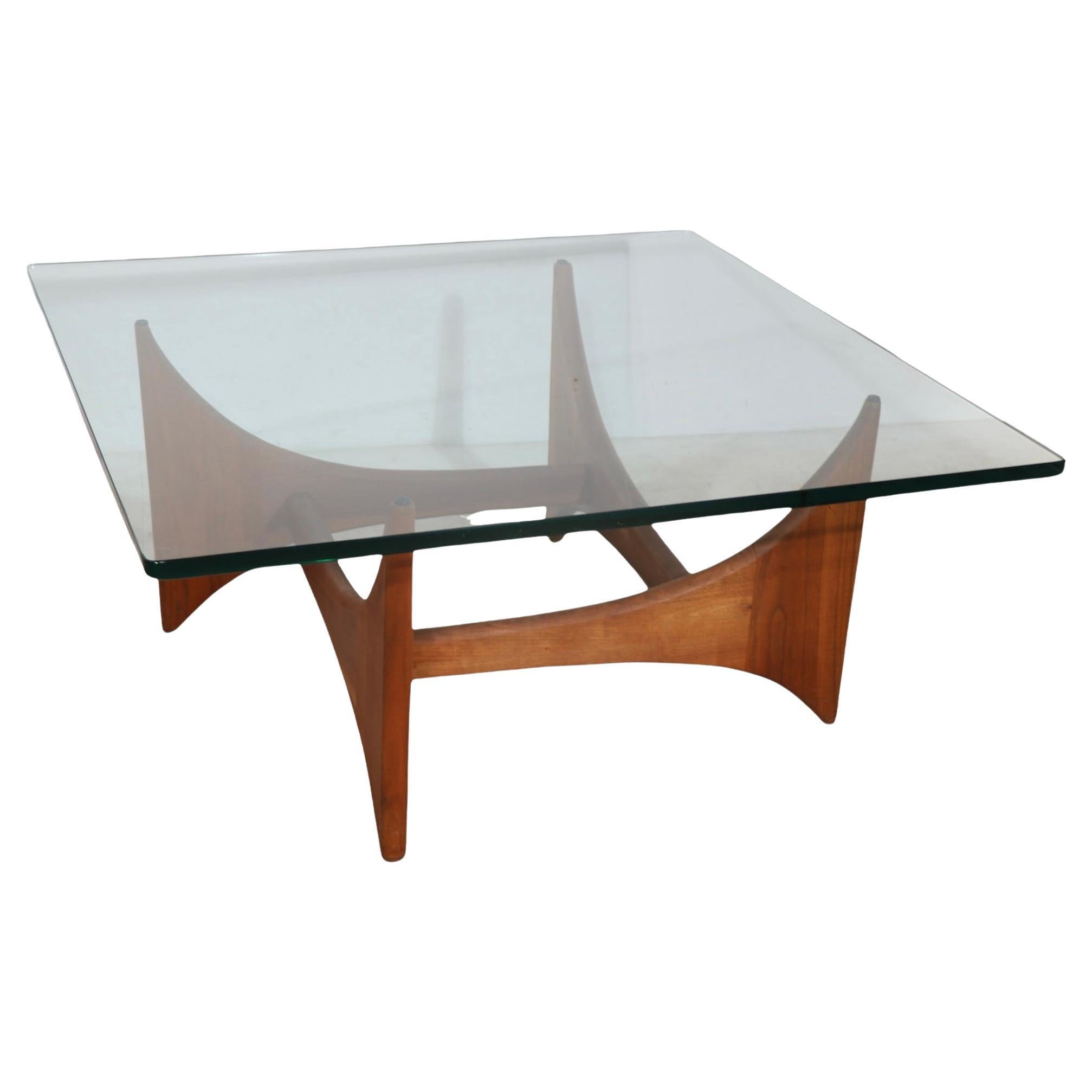 Sculptural mid century coffee table by Adrian Pearsall having solid wood base and thick ( .75” ) thick glass top.
This example is. Very fine, original, clean and ready to use condition showing only light cosmetic wear normal and consistent with