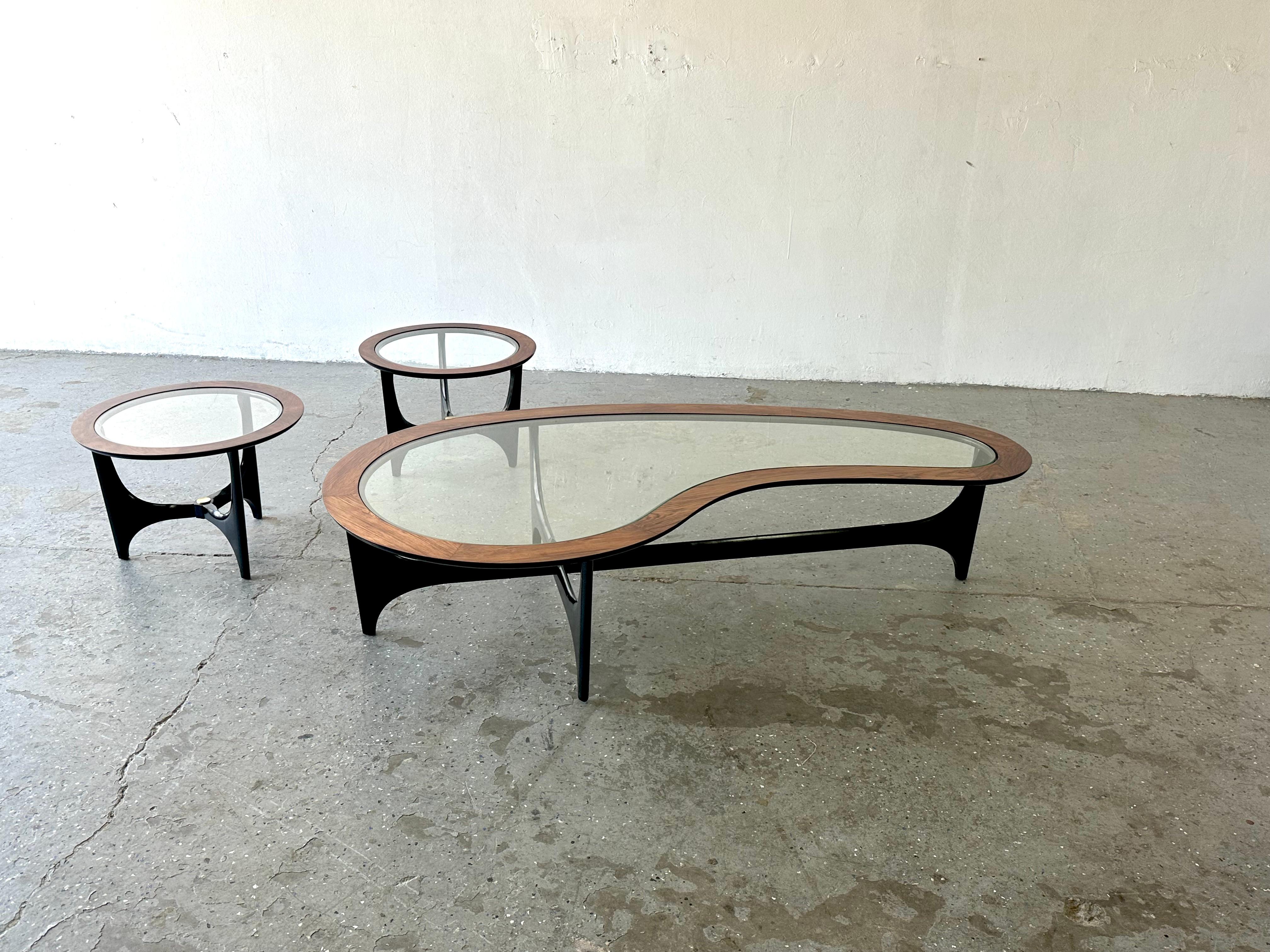 This rosewood Biomorphic / Kidney shaped coffee table & pair of round matching side tables set is often attributed to Adrian Pearsall but is designed by André Bus, for Lane as part of the 