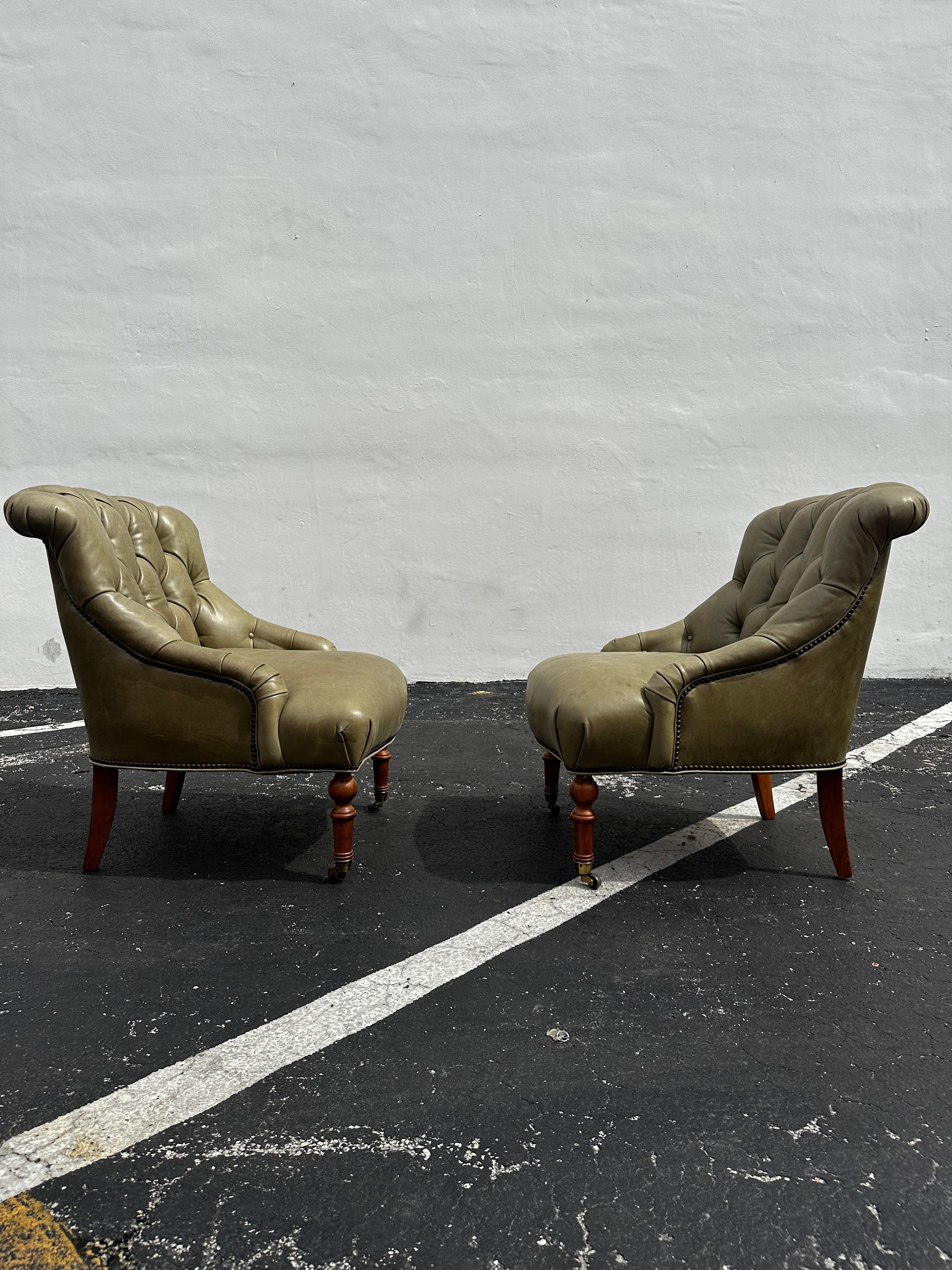 Transport yourself back to the sleek and sophisticated 1990s with this exquisite library chair set in a green tufted leather with nailhead trimmings. The ultra rare chairs on front castors exudes an air of luxury and refinement. Outstanding design