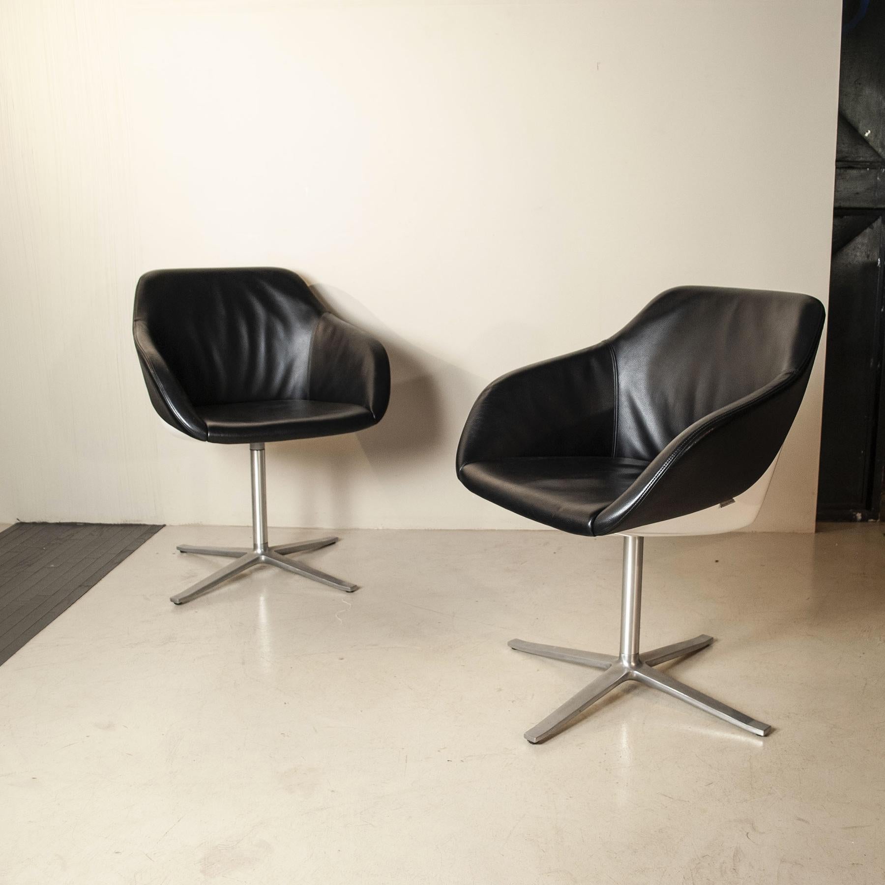 Beautiful shell chairs by the renowned London based design team Pearson Lloyd. The chair has a very stable white plastic shell on the outside, while the inner shell is comfortably upholstered and covered in real leather.

Luke Pearson and Tom