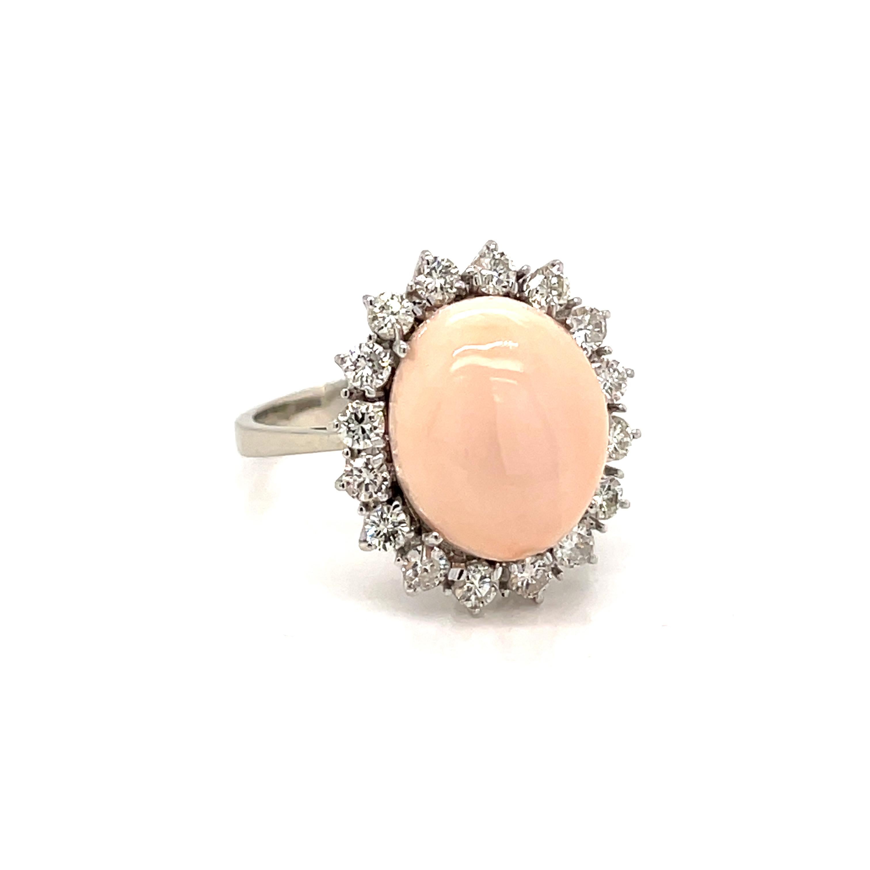 Beautiful Vintage Cocktail Ring mounted in 18k white gold set with a natural, of great quality, Peau D'Ange/Angel skin Coral surrounded by 1 carat of Round brilliant cut diamonds graded G color Vvs clarity 
Made in Italy, circa 1980

CONDITION:
