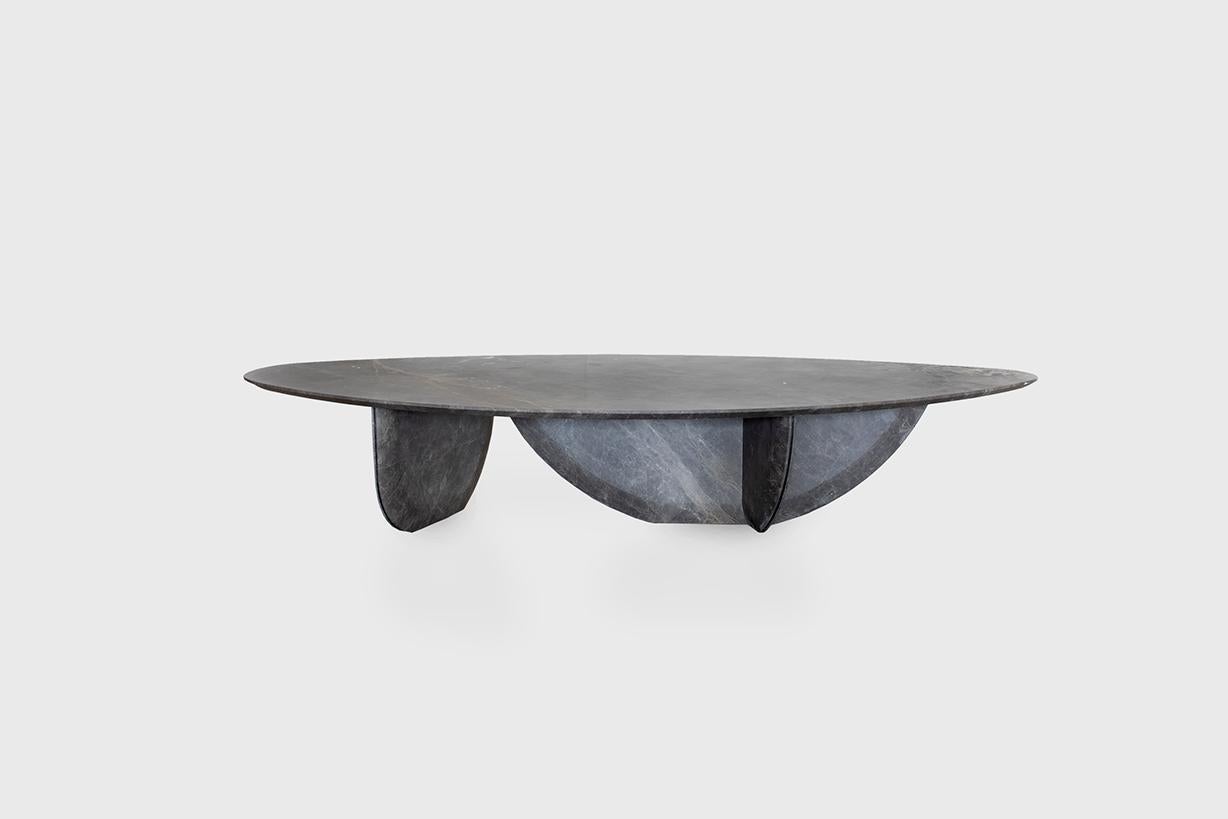 Pebble coffee table by Atra Design.
Dimensions: D 174 x W 77.7 x H 32.2 cm.
Materials: Mystic Grey marble top, blackened steel base.
Also available in different stones.  

Atra Design
We are Atra, a furniture brand produced by Atra form a mexico