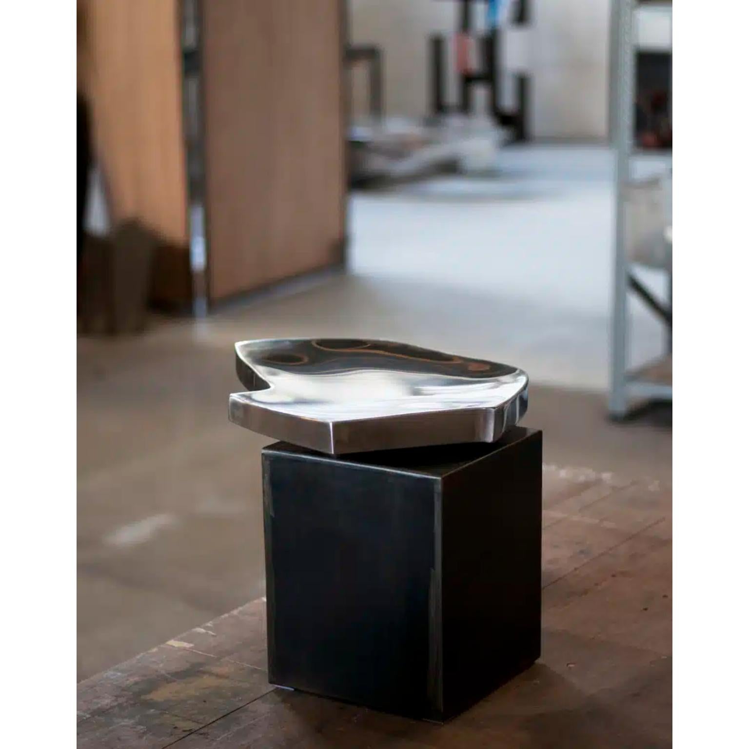 Pebble Side Table by Pol Quadens 
Limited Edition Of 24+4 Pieces.
Dimensions: D 55 x W 55 x H 35 cm.
Materials: Polished stainless steel and linen.

Pol Quadens was born in Brussels. His father was active in the fields of composites the metal