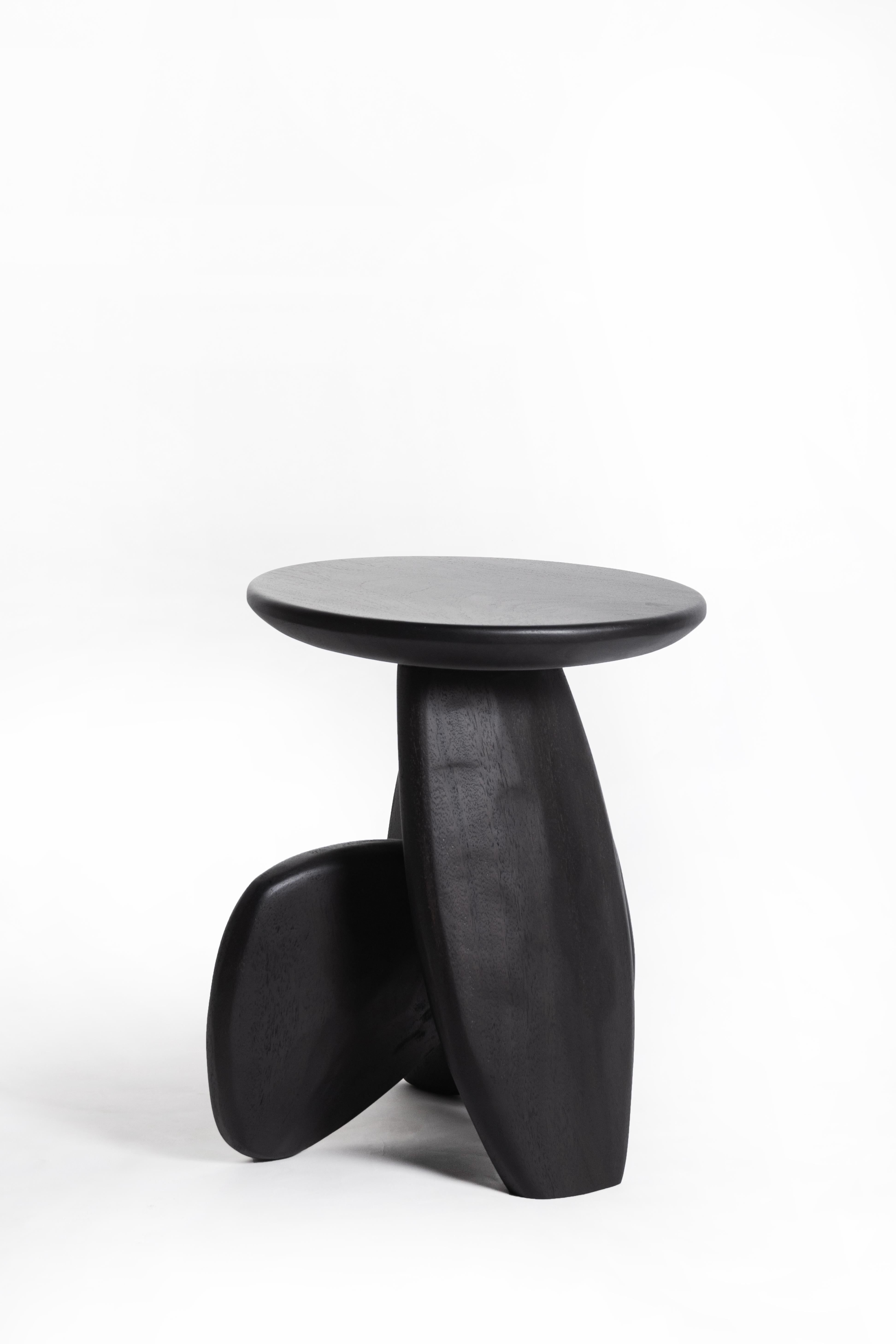 A three-legged wooden stool that looks like the arrangement of rock to form a structure. This work was born from the skill and instinct of a master craftsman where designers give the artisan a chance to create works without a clear plan until