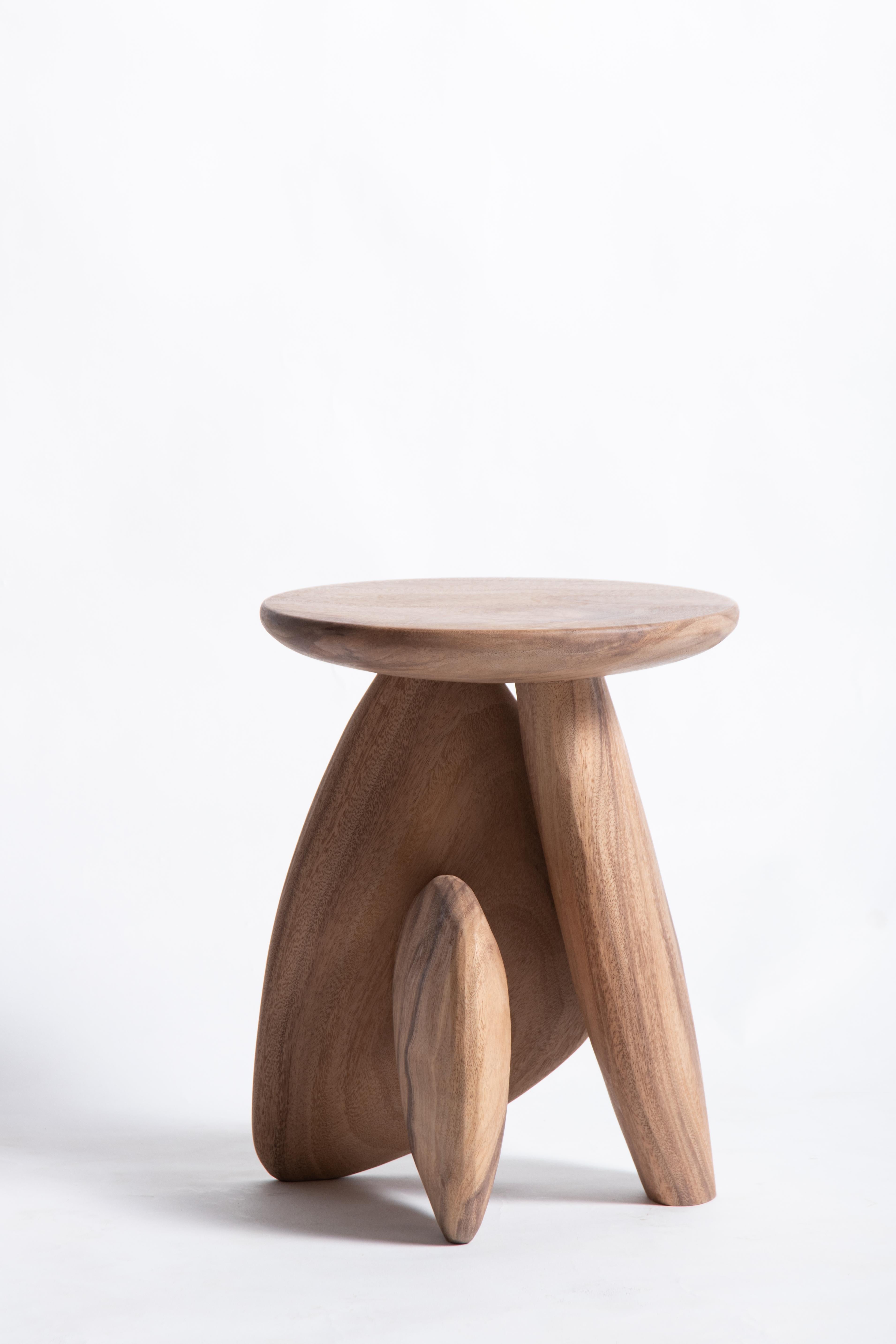 A three-legged wooden stool that looks like the arrangement of rock to form a structure. This work was born from the skill and instinct of a master craftsman where designers give the artisan a chance to create works without a clear plan until