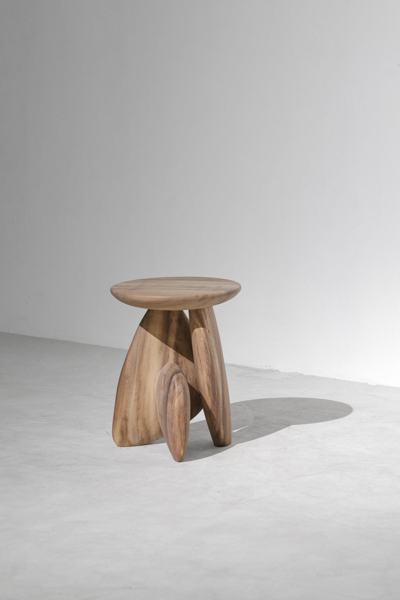 A three-legged wooden stool that looks like the arrangement of rock to form a structure. This work was born from the skill and instinct of a master craftsman where designers give the artisan a chance to create works without a clear plan until