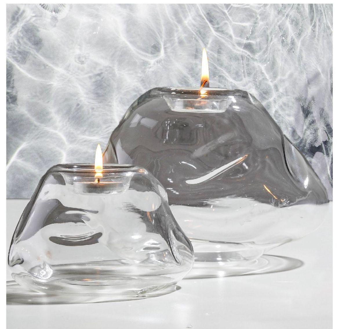 Pebble tea lights are sculptural blown glass votives inspired by small stones one finds next to a flowing stream near the mountains.

These set of two pebble tea light holders, inspired by winding mountain roads add understated minimal elegance to