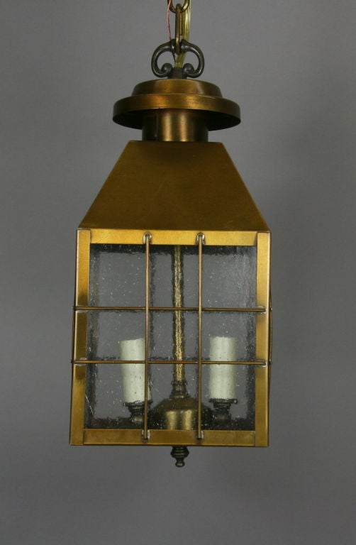 A brass lantern with four pebbled glass panels. Two light.
 (Two available).
Priced individually.