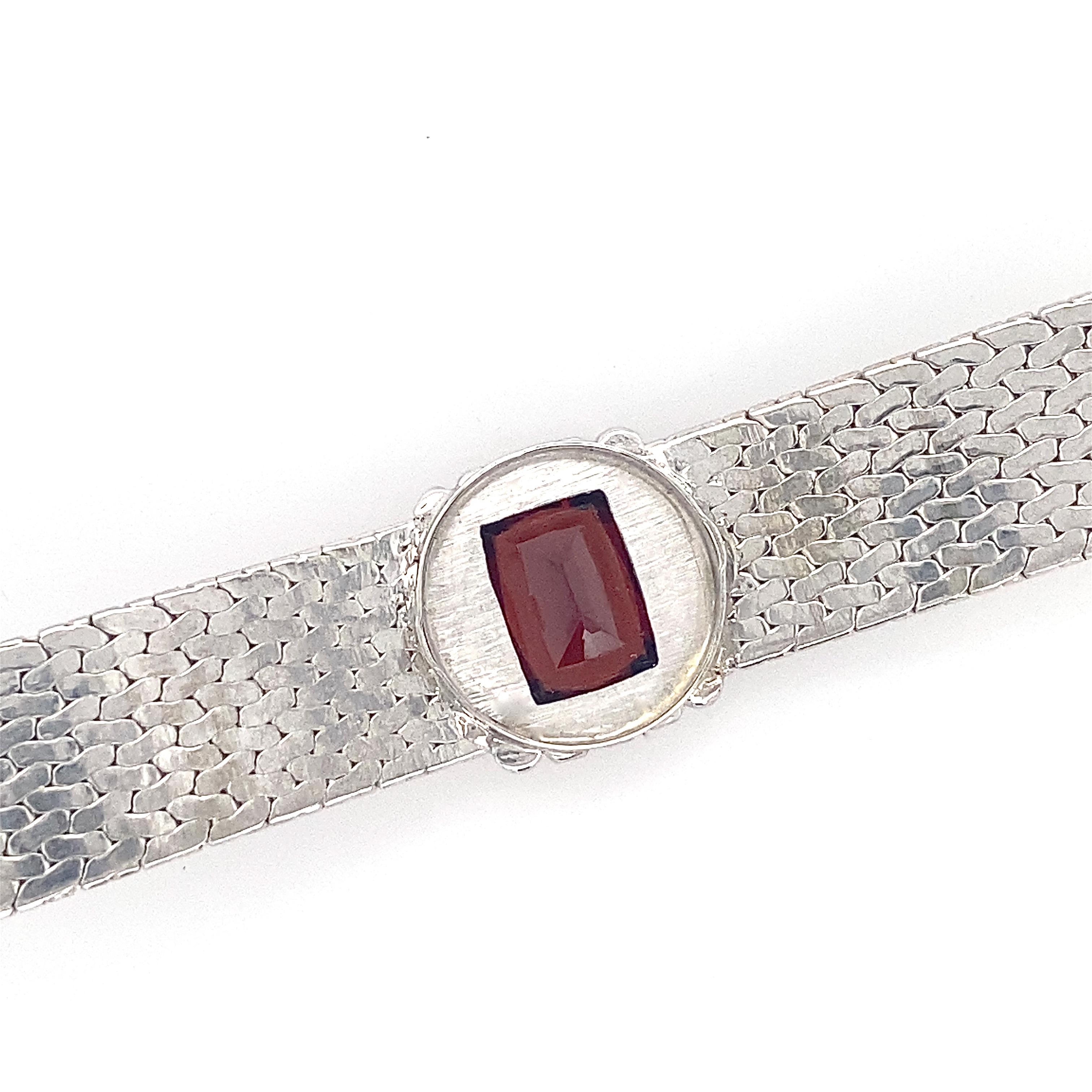 Women's Pebbled White Gold Bangle Bracelet with Garnet in Diamond Halo