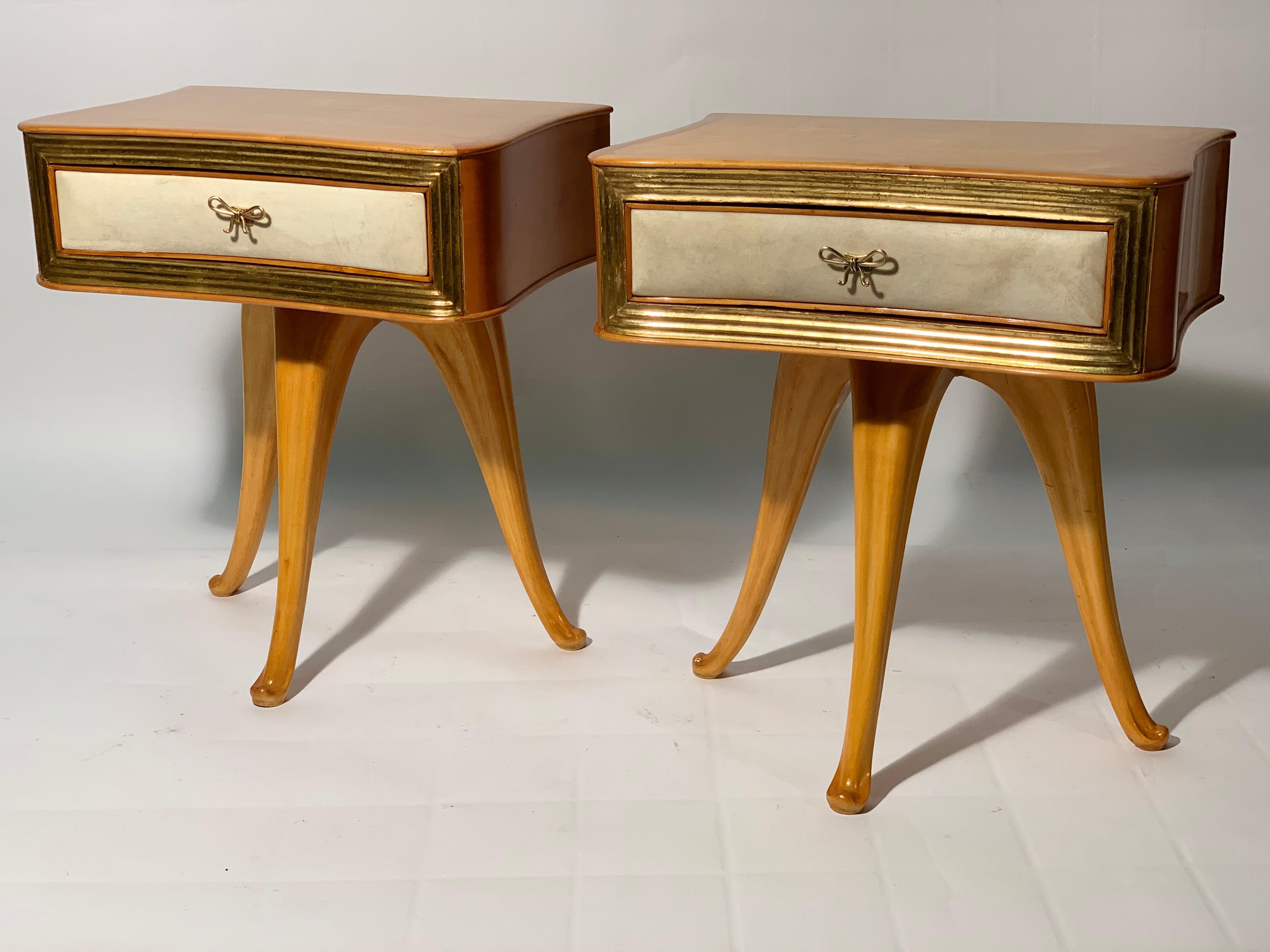Night stands or side table in solid sculptured maples 3 legs structures, convex and concave drawer in the central part covered in natural parchment and framed with grooved decorative details in real gold leaf.
Beautiful bow-shaped handles in cast