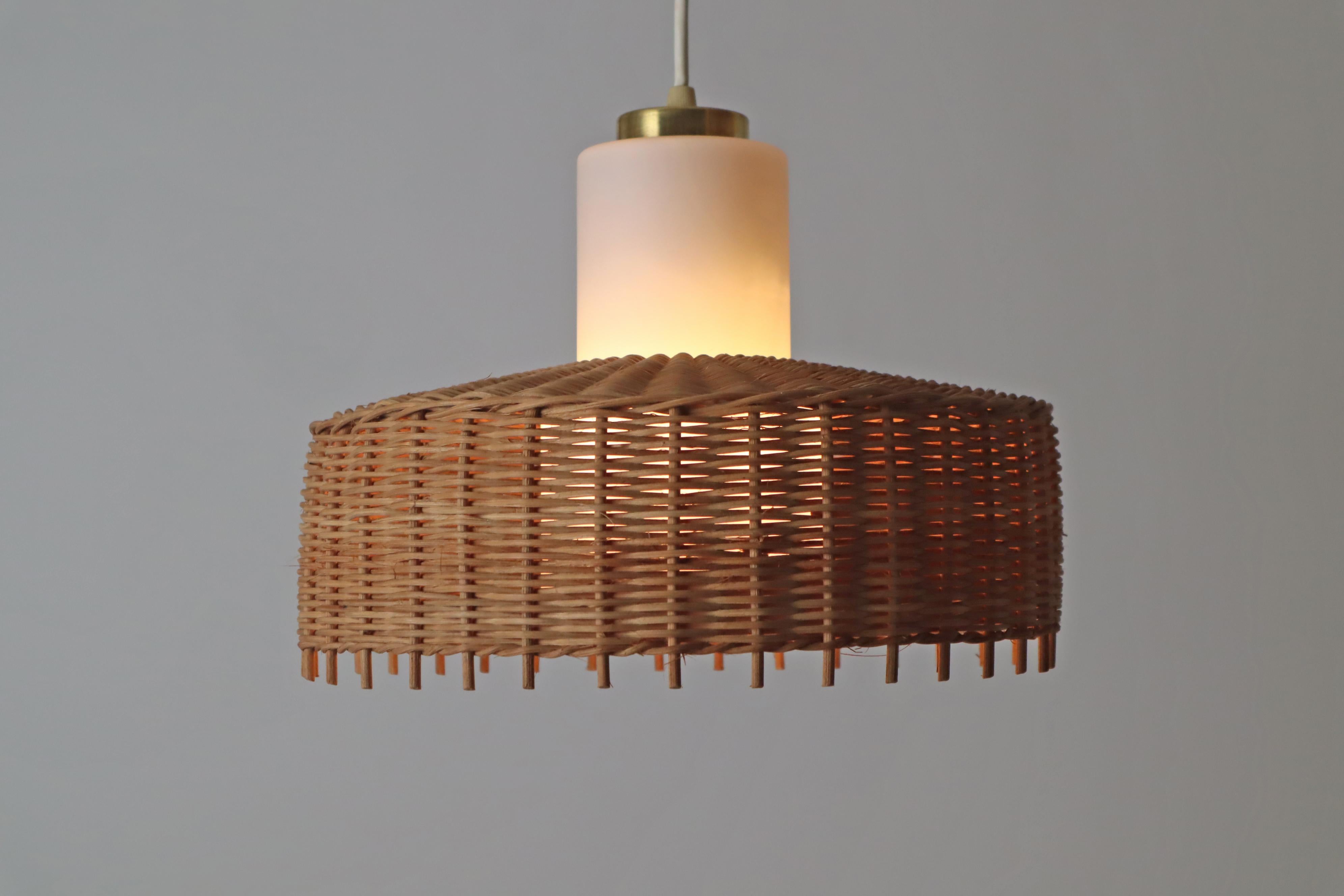This hanging lamp is simple and timeless, handcrafted combined with excellent glass art. The lampshade was made by hand by select craftsmen and has acquired a beautiful patina over the decades. The simple opal glass completes the beautiful overall