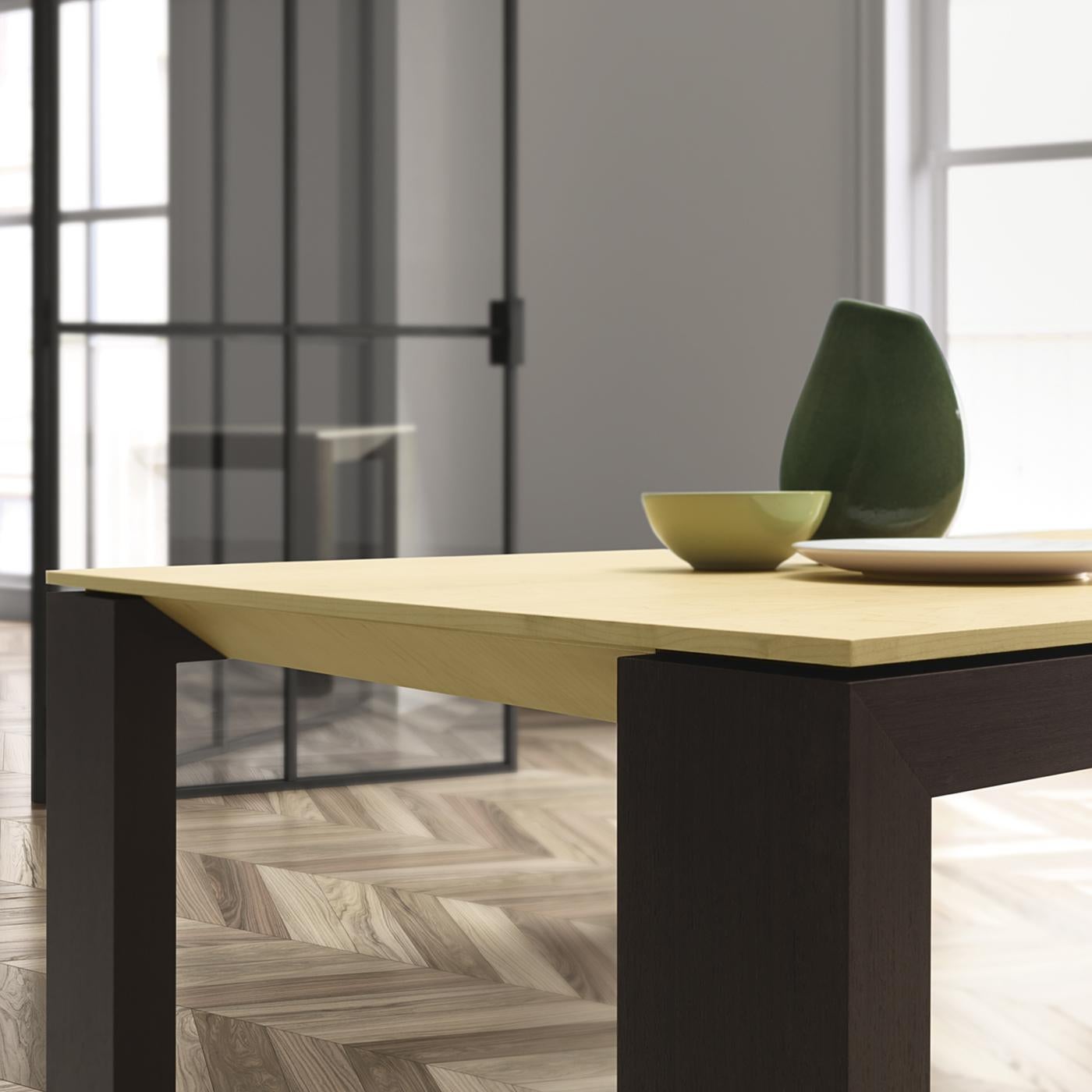 This all-wood table will be a beautiful centerpiece for any dining or living space with a contemporary flare. Sleek design and simple forms are what this long, rectangular table is all about, with dark kotò wood frame and legs and a smooth, light