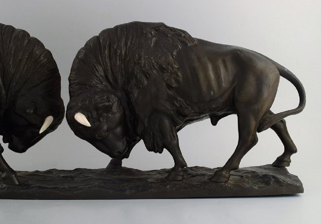 Peder Marius Jensen (1883 - 1925), Danish sculptor. 
Colossal sculpture in patinated bronze. Fighting bisons. Horns made of bone. 
Early 20th century.
Measures: 75 x 25 x 16 cm.
In excellent condition with minor wear.
Signed.