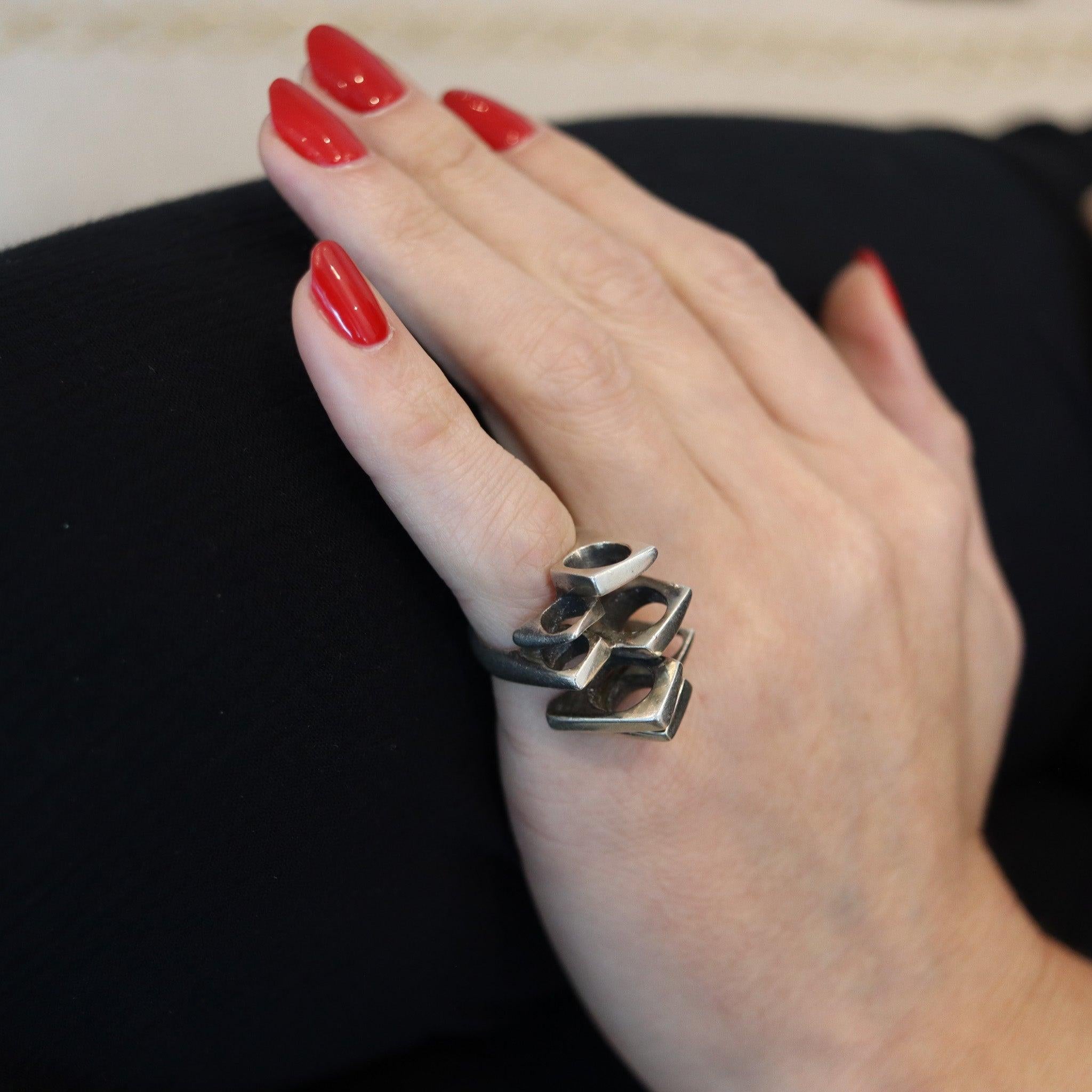 Geometric ring designed by Peder Musse.

This geometric cocktail ring was created in Denmark by the jewelry designer Peder Musse, back in the 1970. The sculptural ring has been designed following the Spatialism art parameters, in solid .925/.999