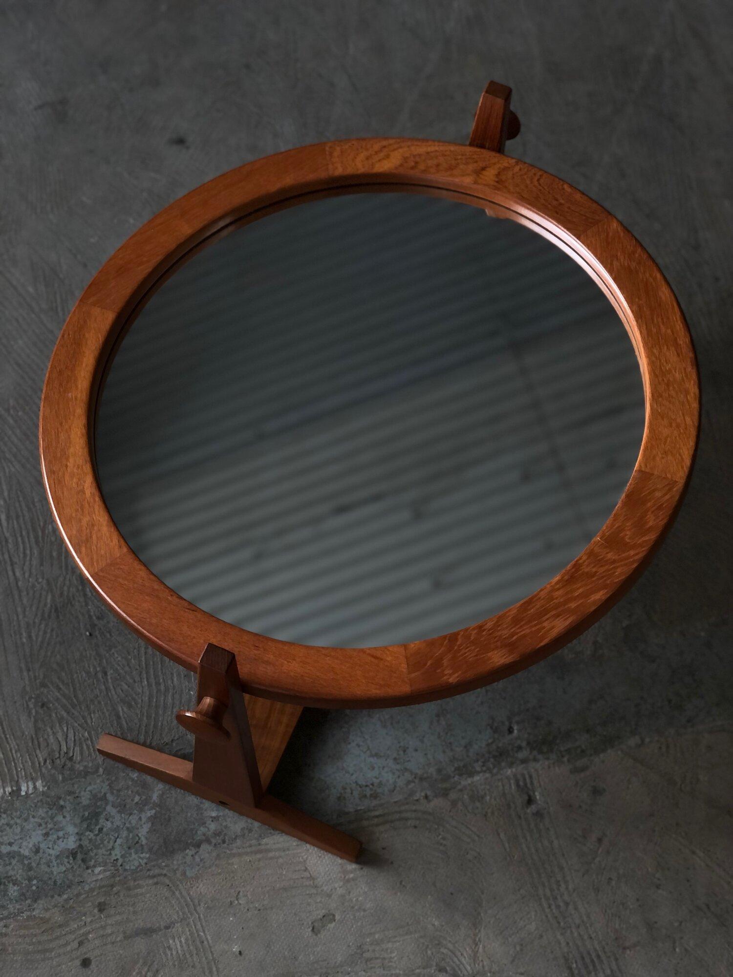 Solid teak tilting table-top mirror by Pedersen and Hansen, Denmark. This piece features nice finger joinery detailing on the frame and turned knobs that allow for adjustment and Measures 27” W x 11.25” D x 25” H. Excellent condition.