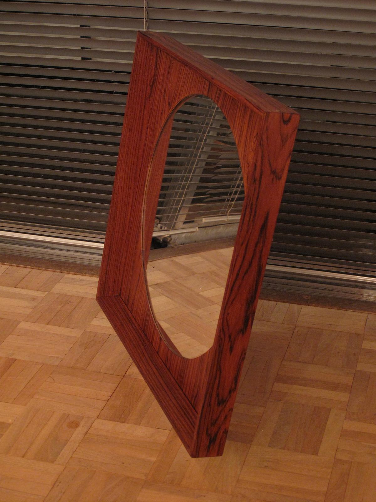 An unusual square framed wall mirror finished in Brazilian rosewood with an attractive beveled edge and circular glass.

Produced to a very high standard by Pedersen & Hansen of Denmark. We have not seen another example like this, it appears to be